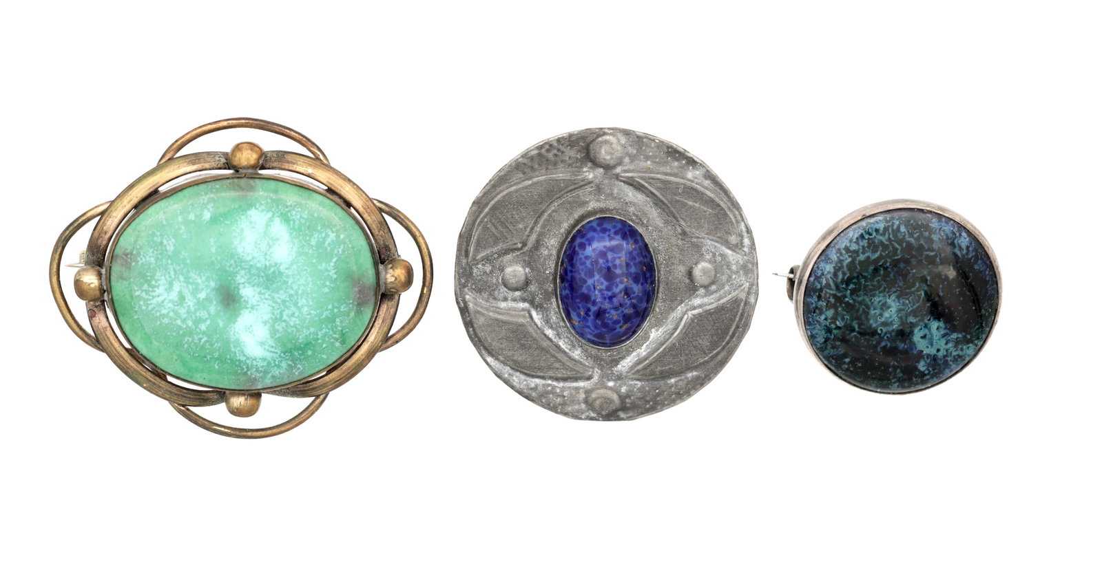 A COLLECTION OF THREE RUSKIN POTTERY PLAQUE BROOCHES: A COLLECTION OF THREE RUSKIN POTTERY PLAQUE BROOCHES comprising an oval green plaque in a gilt metal openwork mount, a circular pewter example set with a mottled blue cabochon, and a circular English