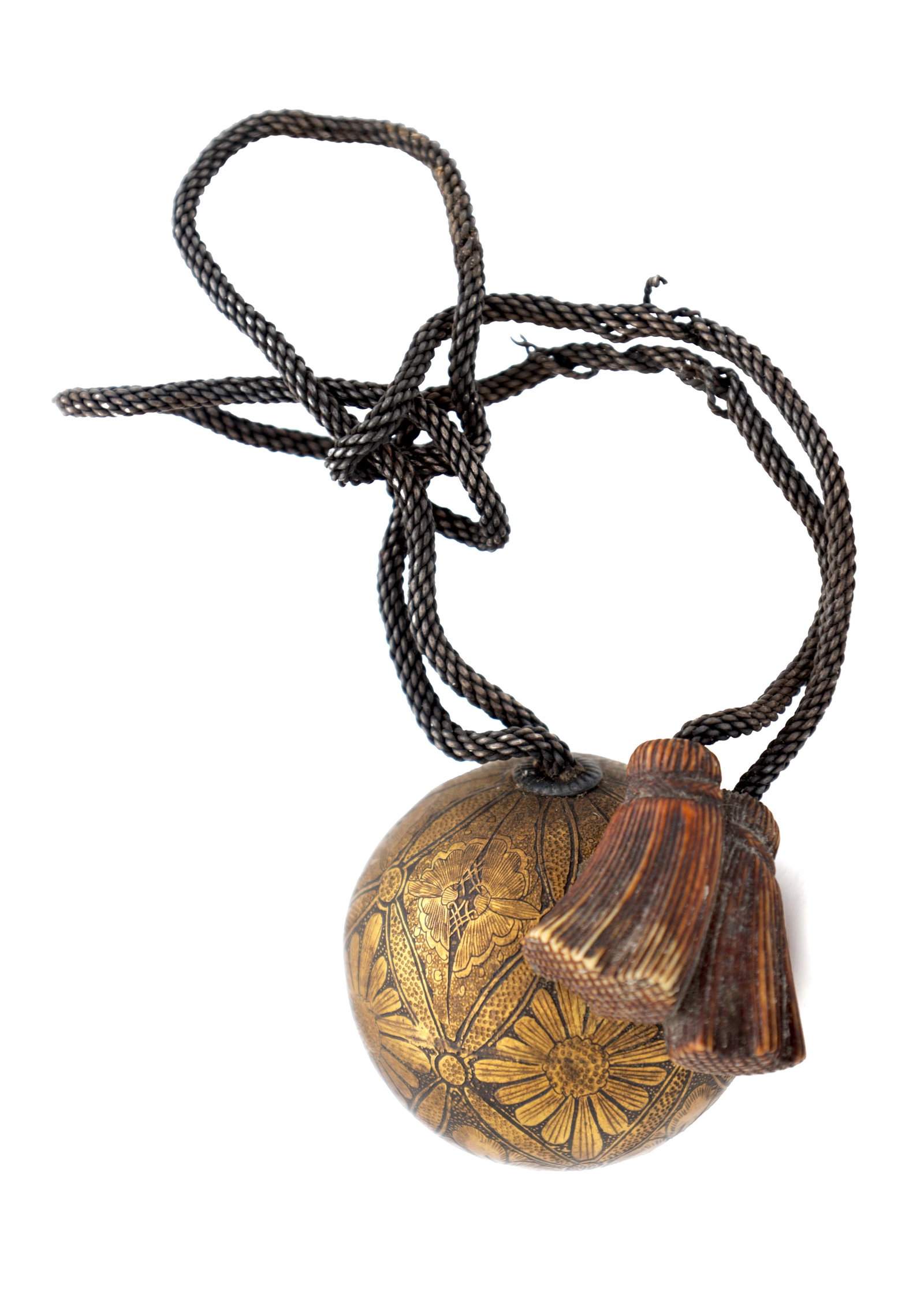 A JAPANESE MEIJI PERIOD SHAKUDO AND MIXED METAL TEMARI BALL TOGGLE NETSUKE: A JAPANESE MEIJI PERIOD SHAKUDO AND MIXED METAL TEMARI BALL TOGGLE NETSUKE of spherical form with gilt floral panels and suspension ring, on a braided cord with a carved wood double tassel. (50mm high