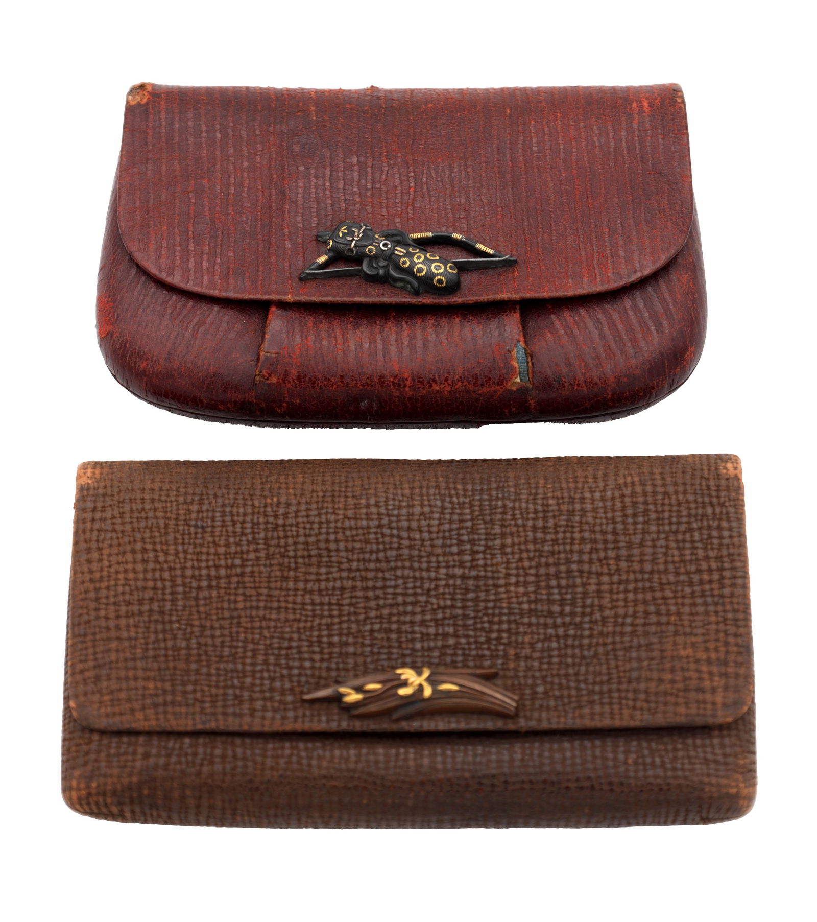 TWO MEIJI JAPANESE LEATHER PURSES WITH MIXED METAL MOUNTS: TWO MEIJI JAPANESE LEATHER PURSES WITH MIXED METAL MOUNTS each of rectangular wallet form with flap closure, the applied mixed metal mounts with gilt highlights, one depicting an insect and the other