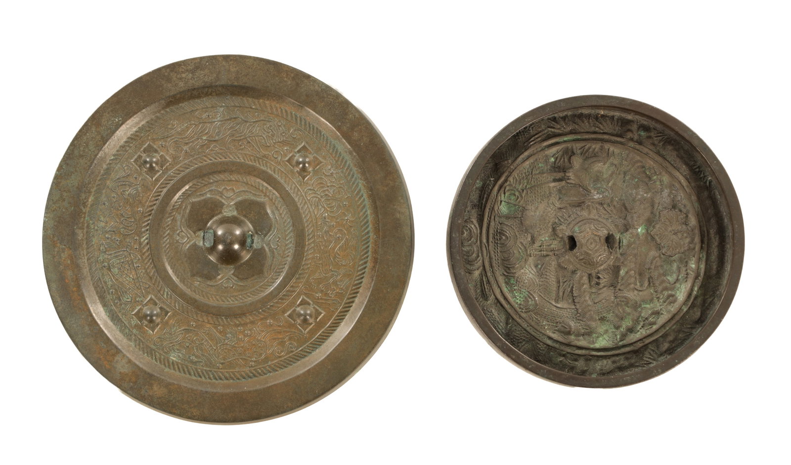 TWO CHINESE BRONZE MIRRORS: TWO CHINESE BRONZE MIRRORS each of circular form, one cast in relief with a central boss surrounded by stylised animals and geometric borders, the other decorated with storks amidst scrolling clouds,