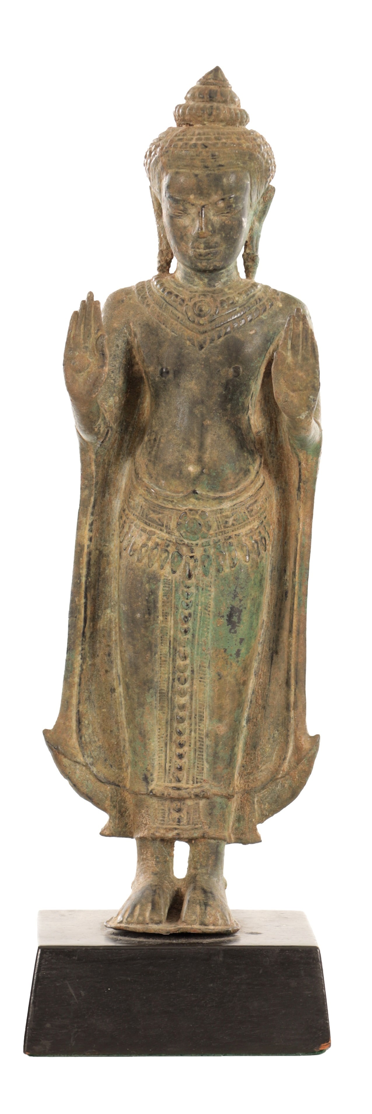 A SOUTHEAST ASIAN BRONZE STANDING BUDDHA ON WOOD STAND: A SOUTHEAST ASIAN BRONZE STANDING BUDDHA ON WOOD STAND cast standing with both hands raised in abhaya mudra, wearing a pleated robe and beaded jewellery, the hair in tight curls with high ushnisha, a