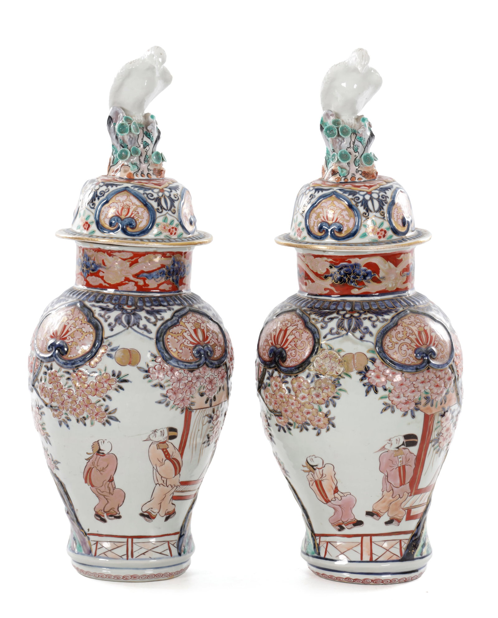 A PAIR OF LATE 18TH CENTURY JAPANESE IMARI PORCELAIN VASES AND COVERS: A PAIR OF LATE 18TH CENTURY JAPANESE IMARI PORCELAIN VASES AND COVERS each of baluster form with domed covers surmounted by white glazed eagle finials, the bodies decorated with flowering branches, sh