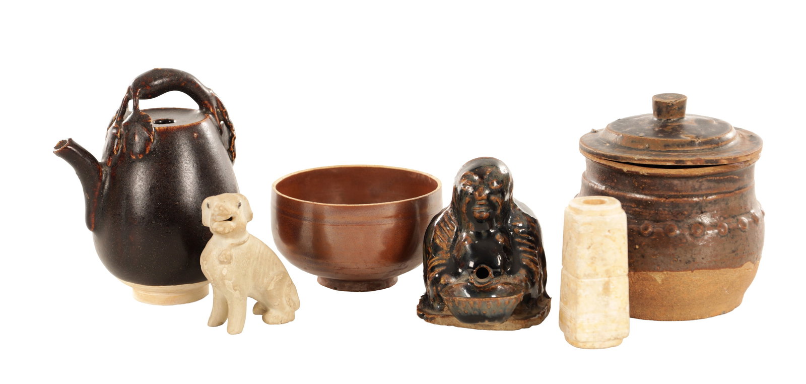 A GROUP OF SEVEN ASIAN CERAMIC AND STONE ITEMS: A GROUP OF SEVEN ASIAN CERAMIC AND STONE ITEMS comprising a brown-glazed tea bowl of rounded form, a dark-glazed lidded jar with applied stud decoration, a dark-glazed pottery teapot with overhead han