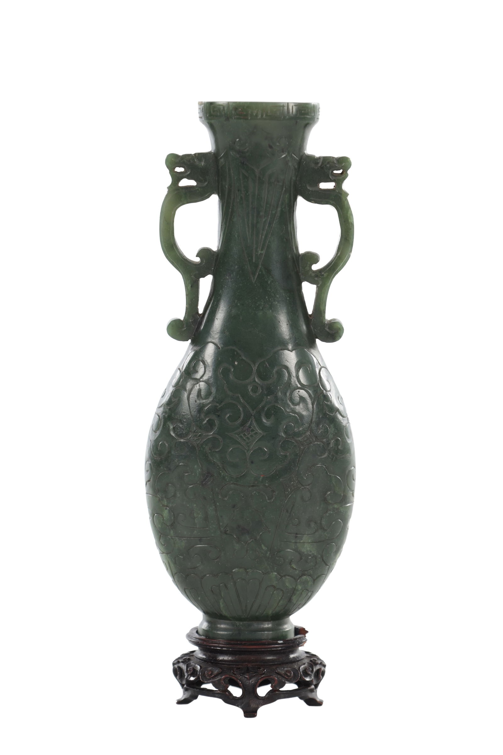 A CHINESE JADE TWIN HANDLED VASE: A CHINESE JADE TWIN HANDLED VASE of baluster form with a flared neck and twin dragon form handles, carved in relief with scrolling archaistic motifs, the dark green jade raised on a carved hardwood st