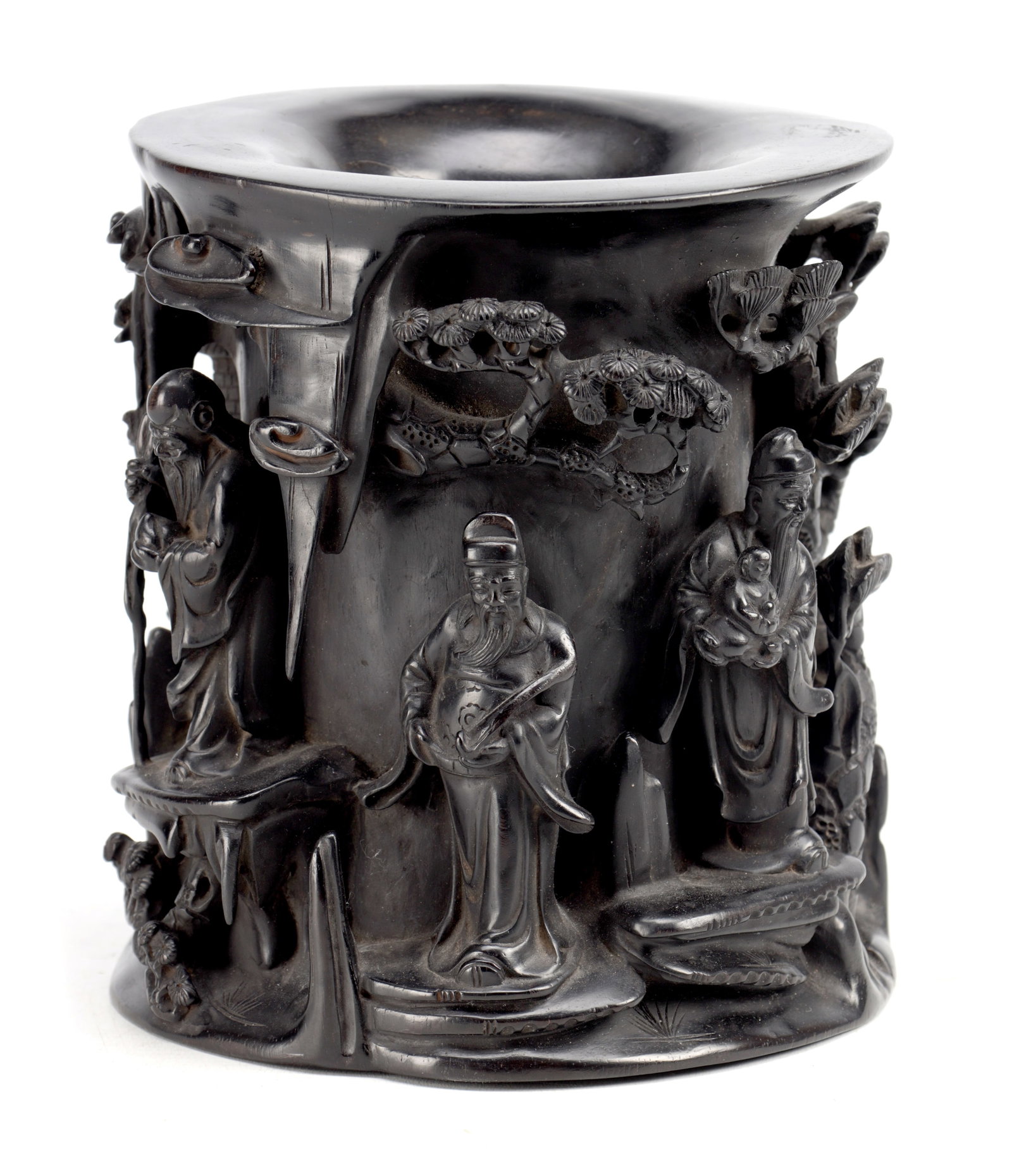 A CHINESE CARVED HARDWOOD BRUSH POT WITH IMMORTALS IN LANDSCAPE: A CHINESE CARVED HARDWOOD BRUSH POT WITH IMMORTALS IN LANDSCAPE of cylindrical form with an everted rim, deeply carved in high relief with sages and attendants beneath pine trees among rockwork and cl