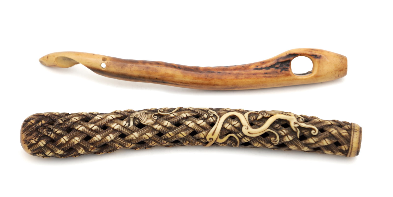 TWO 19TH CENTURY JAPANESE CARVED STAG ANTLER PIPE CASES: TWO 19TH CENTURY JAPANESE CARVED STAG ANTLER PIPE CASES the first carved in openwork basket weave with a sinuous dragon in relief, the second of naturalistic curved form with a large himotoshi apertur