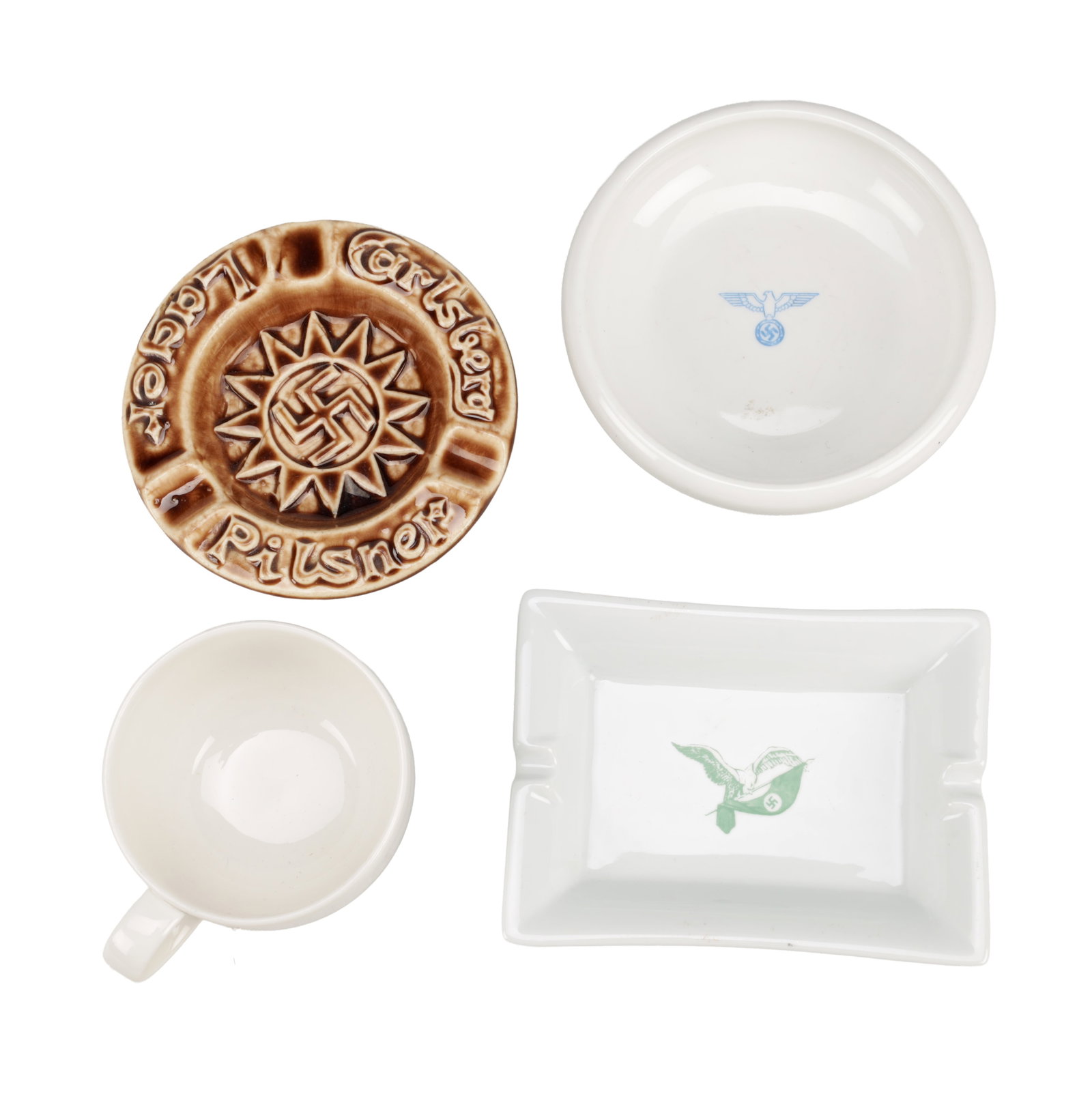 FOUR WWII GERMAN CERAMIC ITEMS: FOUR WWII GERMAN CERAMIC ITEMS comprising a rectangular ashtray printed in green with Reichsadler and swastika, a circular dish printed in blue with eagle and swastika, a brown-glazed Pilsner advertis