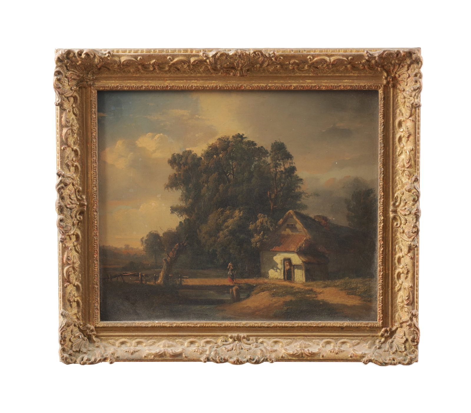A 19TH CENTURY OIL ON BOARD LANDSCAPE WITH COTTAGE AND FIGURE: A 19TH CENTURY OIL ON BOARD LANDSCAPE WITH COTTAGE AND FIGURE depicting a rural scene with a small cottage beside a track, a lone figure crossing a bridge beneath tall trees and a clouded sky, mounted