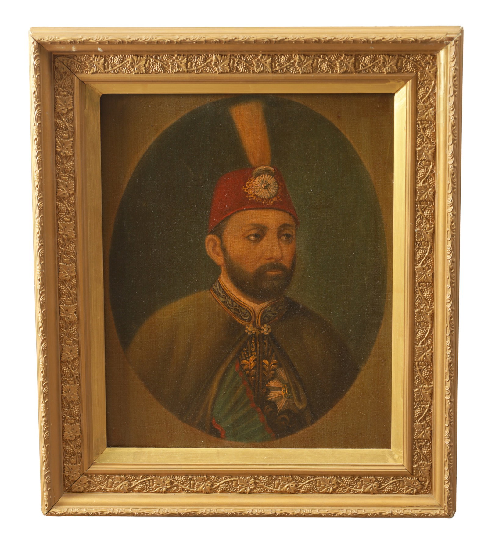 A LATE 19TH CENTURY OIL ON CANVAS PORTRAIT: A LATE 19TH CENTURY OIL ON CANVAS PORTRAIT depicting a half-length portrait of Sultan Abdülaziz wearing a red fez with badge and an embroidered coat on a dark ground within an oval reserve, mounted i