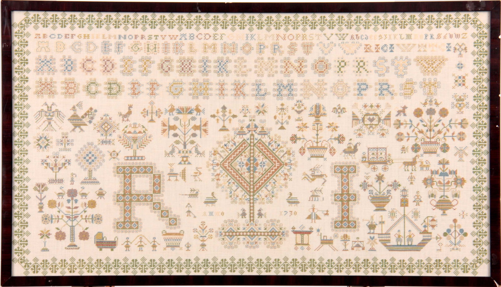 AN 18TH CENTURY STYLE LARGE NEEDLEWORK SAMPLER: AN 18TH CENTURY STYLE LARGE NEEDLEWORK SAMPLER with geometric border enclosing alphabets, flowering urns, trees, birds and figures surrounding a large centre motif and date 1730 - glazed modern frame.