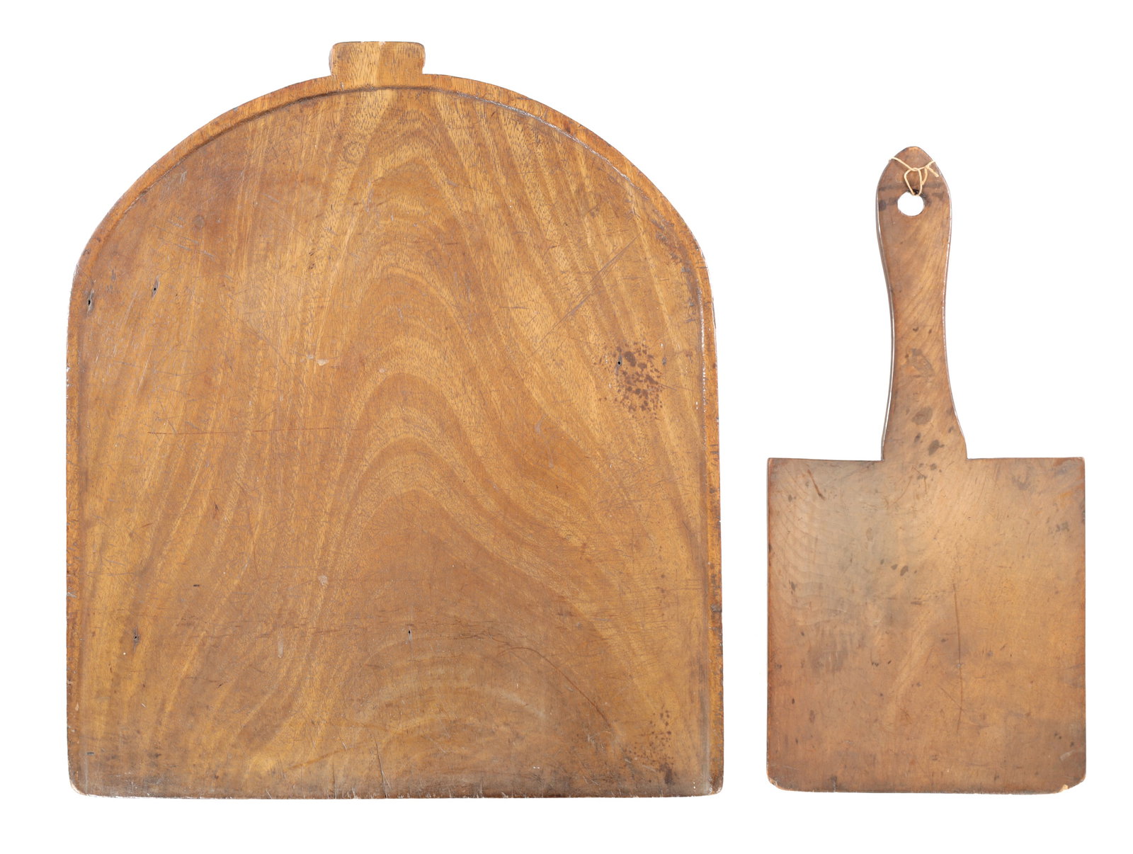 TWO GEORGIAN MAHOGANY CULINARY IMPLEMENTS A BREAD PADDLE AND A LARGE BOARD: TWO GEORGIAN MAHOGANY CULINARY IMPLEMENTS A BREAD PADDLE AND A LARGE BOARD the paddle with a square blade and waisted handle pierced for suspension, the board of arched rectangular outline with a shal