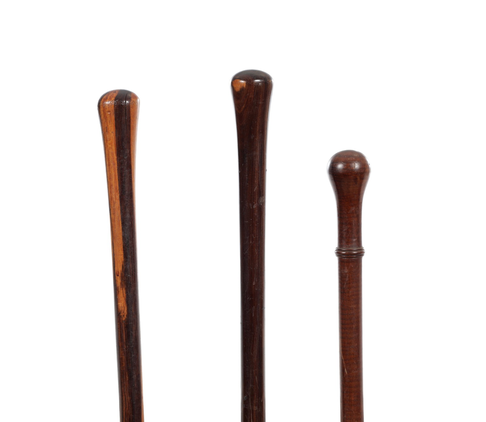 A COLLECTION OF THREE 19TH CENTURY HARDWOOD WALKING CANES: A COLLECTION OF THREE 19TH CENTURY HARDWOOD WALKING CANES two lignum vitae, and one mahogany. (94cm long and smaller)