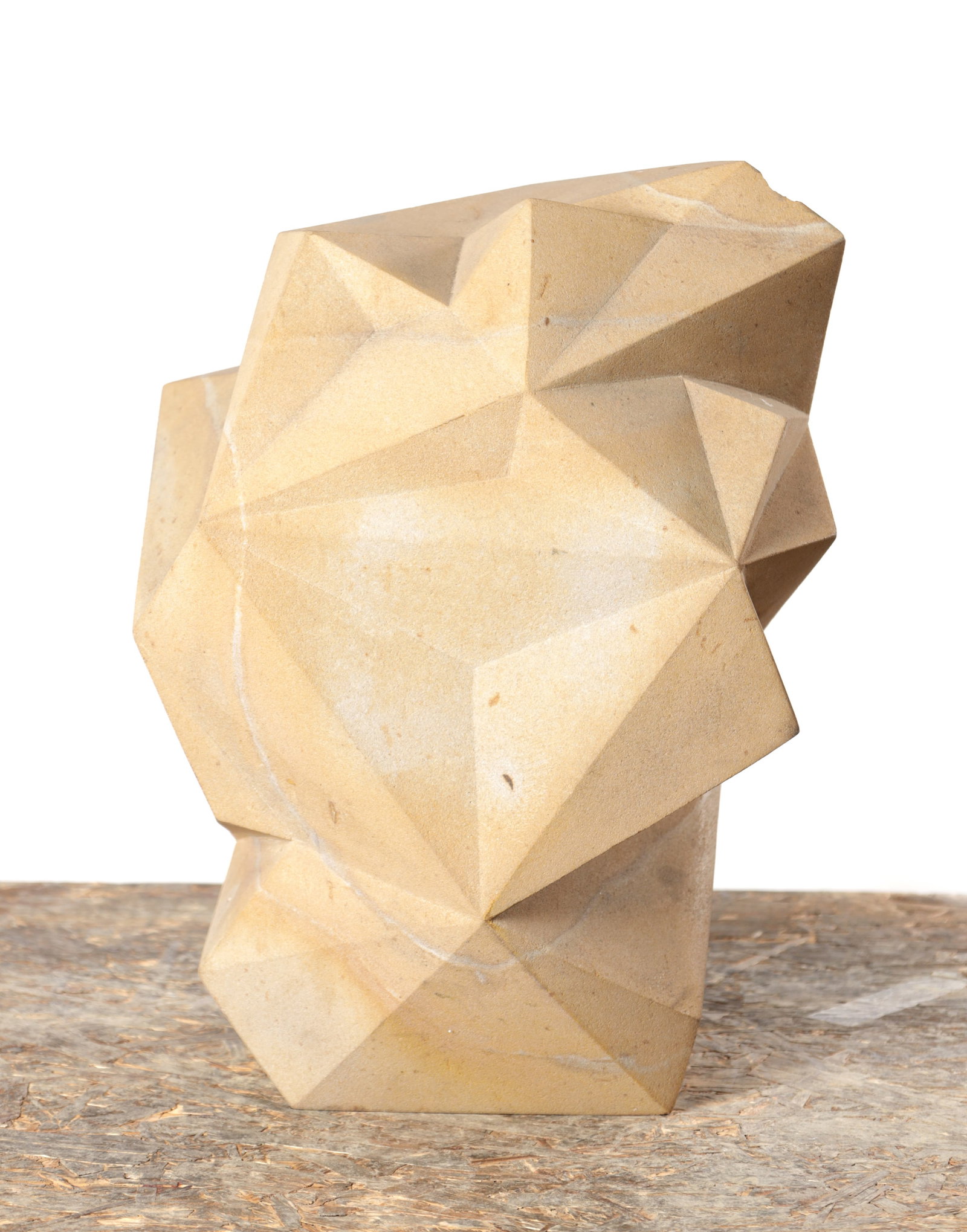 RICHARD PERRY MRSS A CARVED COP CRAG STONE SCULPTURE STAR STONE 2012: RICHARD PERRY MRSS A CARVED COP CRAG STONE SCULPTURE STAR STONE 2012 of faceted geometric abstract form in pale buff stone with natural veining, the work titled Star Stone and dated 2012. (39cm high)
