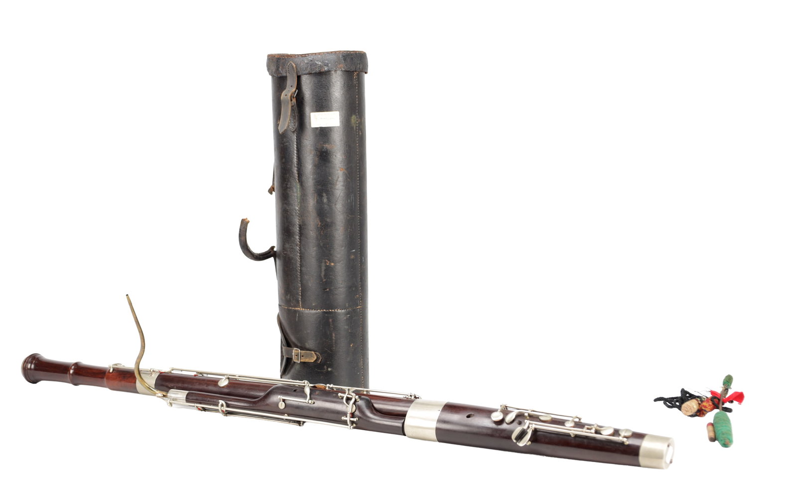 A WOOD BASSOON WITH CASE: A WOOD BASSOON WITH CASE of four-joint form with silver-coloured keywork and metal mounts together with a cylindrical leather case and assorted reeds. (case 63cm high)