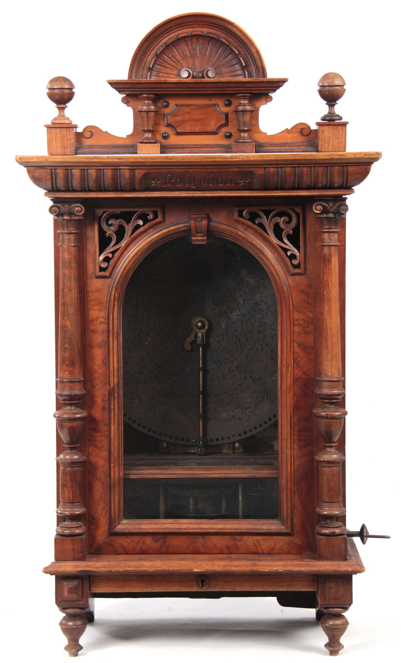 A LATE 19TH CENTURY GERMAN 'PENNY IN THE SLOT' POLYPHON: A LATE 19TH CENTURY GERMAN 'PENNY IN THE SLOT' POLYPHON with arched removable pediment above an arched glazed door flanked by turned columns on turned feet with under-mounted drawer, the interior fitt