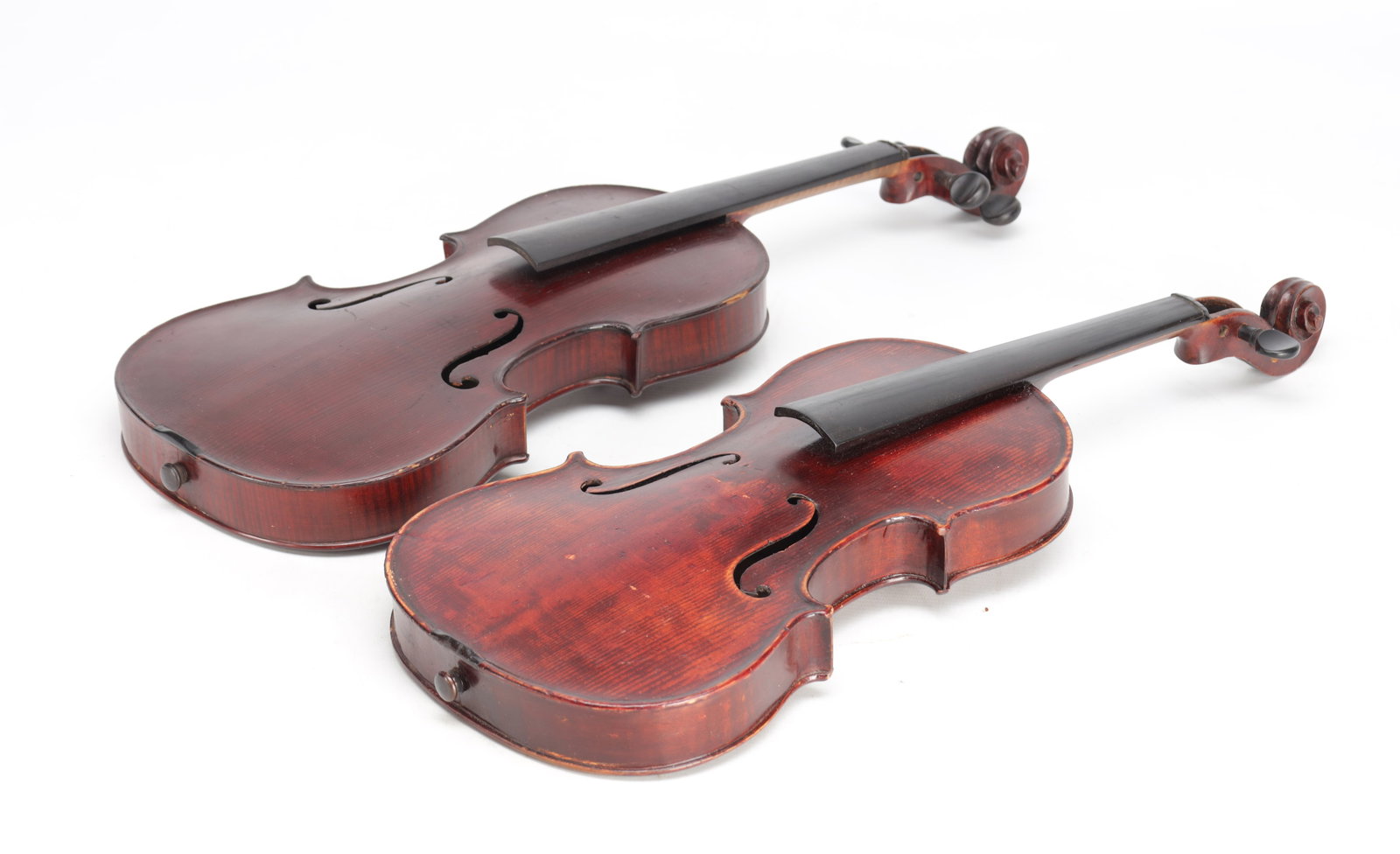 TWO EARLY 20TH CENTURY VIOLINS: TWO EARLY 20TH CENTURY VIOLINS comprising two instruments of standard pattern with carved scrolls and f-holes, one labelled Schmidt Standard. (58cm long; backs 35.7cm and 36cm long)
