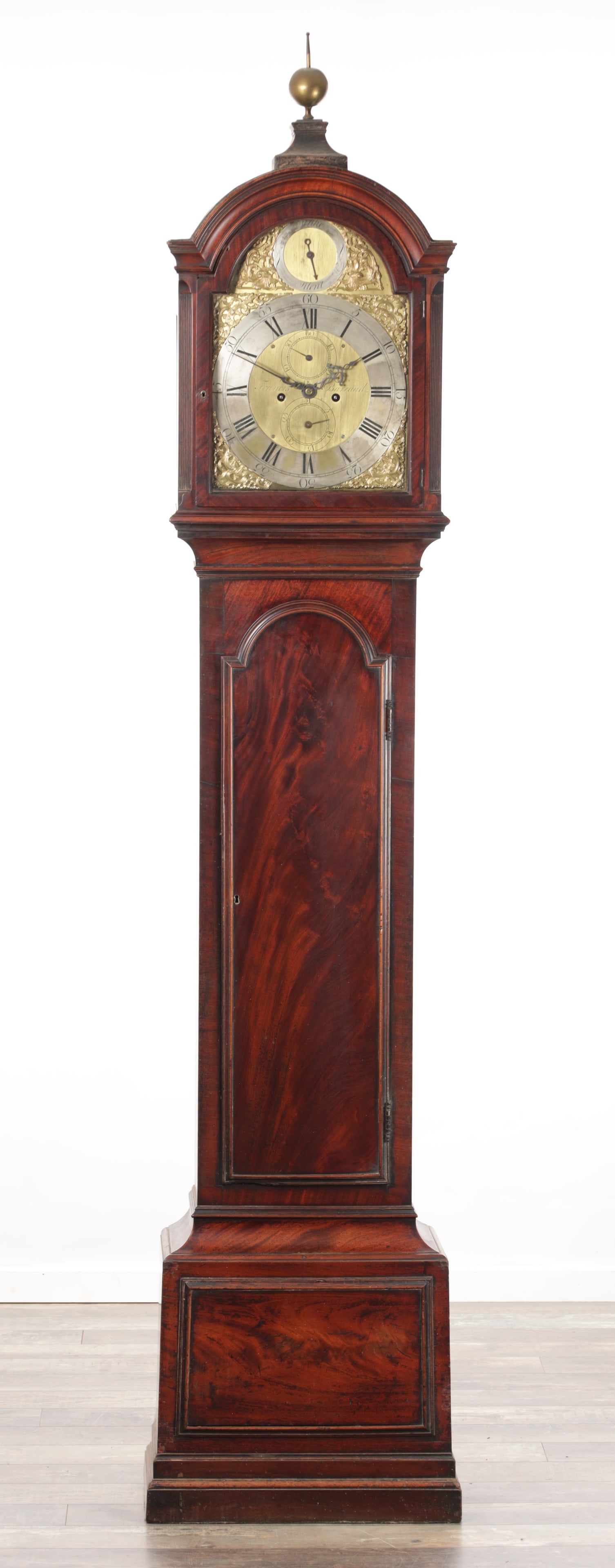 FRANCIS BARRAUD, LONDON. A GEORGE III FIGURED MAHOGANY LONGCASE CLOCK WITH ARCHED BRASS DIAL: FRANCIS BARRAUD, LONDON. A GEORGE III FIGURED MAHOGANY LONGCASE CLOCK WITH ARCHED BRASS DIAL having a Holmes style case with canted hood and moulded arched trunk door on panelled base, the 12 inch arc