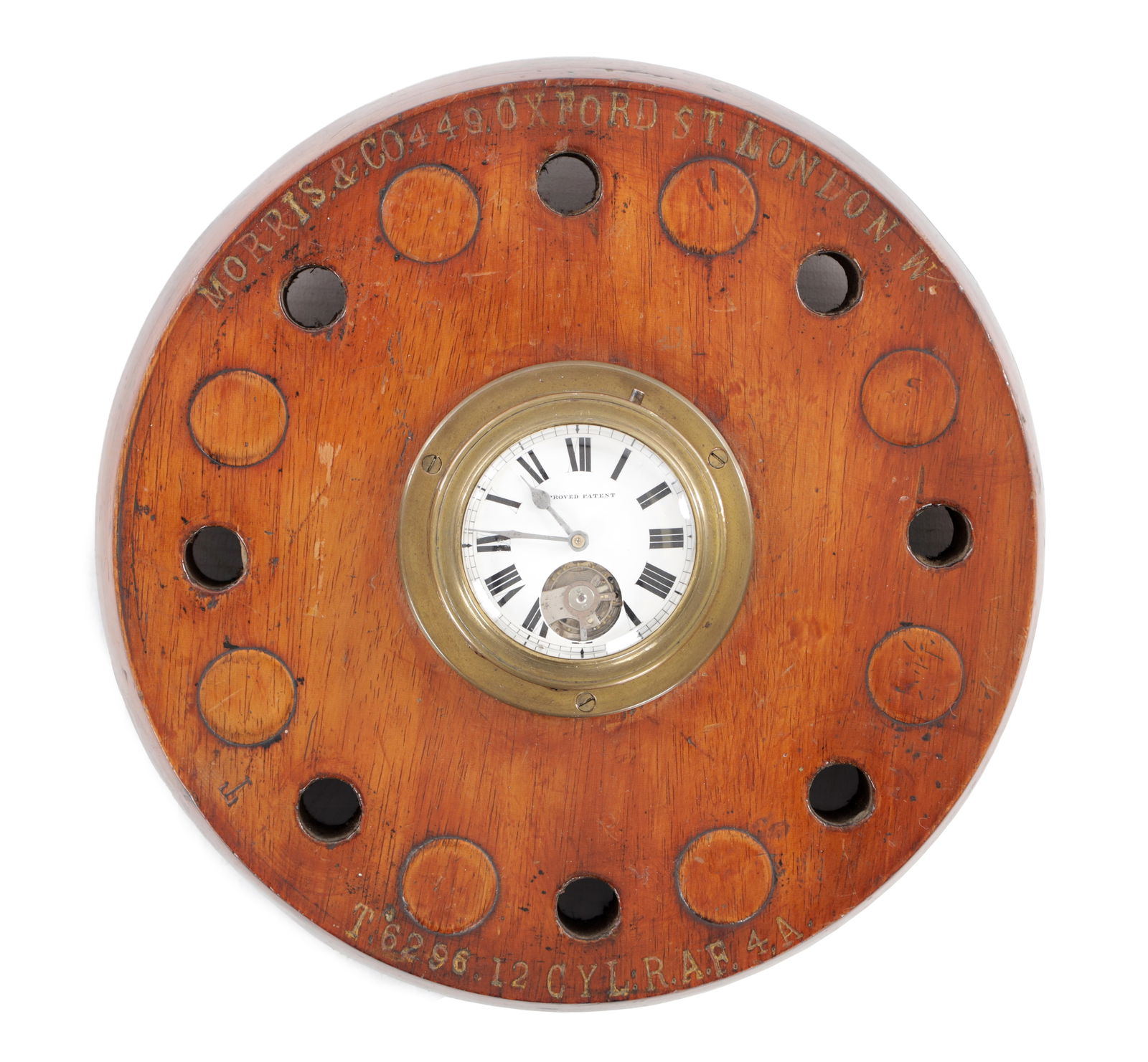 A WWI R.A.F. AIRCRAFT MOMENTO WALL CLOCK: A WWI R.A.F. AIRCRAFT MOMENTO WALL CLOCK constructed from a circular wooden aircraft piston head with applied brass mounted clock with Roman numeral dial and subsidiary visible escapement, the rim ins