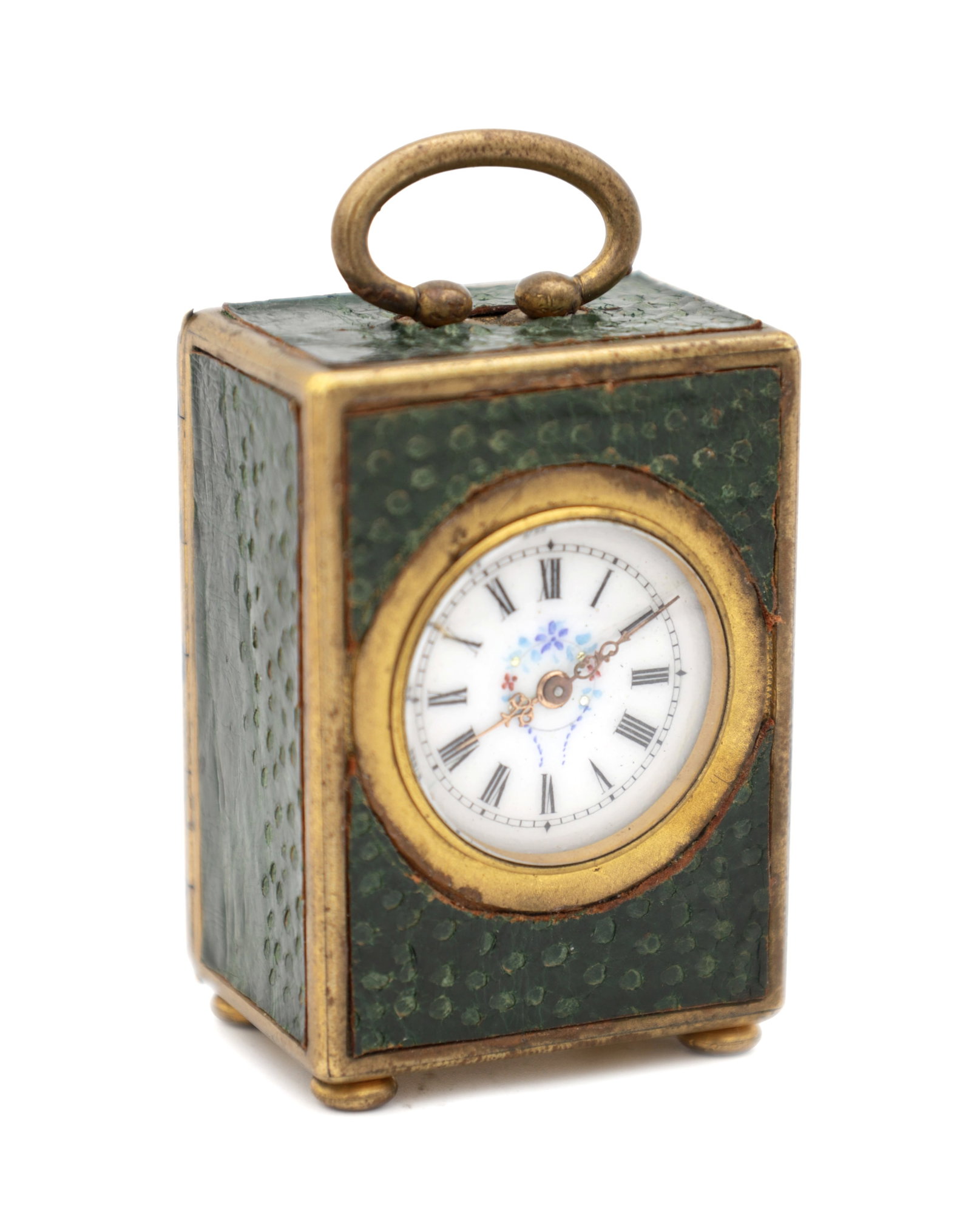 A MINIATURE OSTRICH LEATHER AND GILT METAL BOUDOIR CLOCK: A MINIATURE OSTRICH LEATHER AND GILT METAL BOUDOIR CLOCK eight-day movement with jewelled lever escapement, rectangular case with green ostrich leather panels and gilt metal mounts, enamel dial with R
