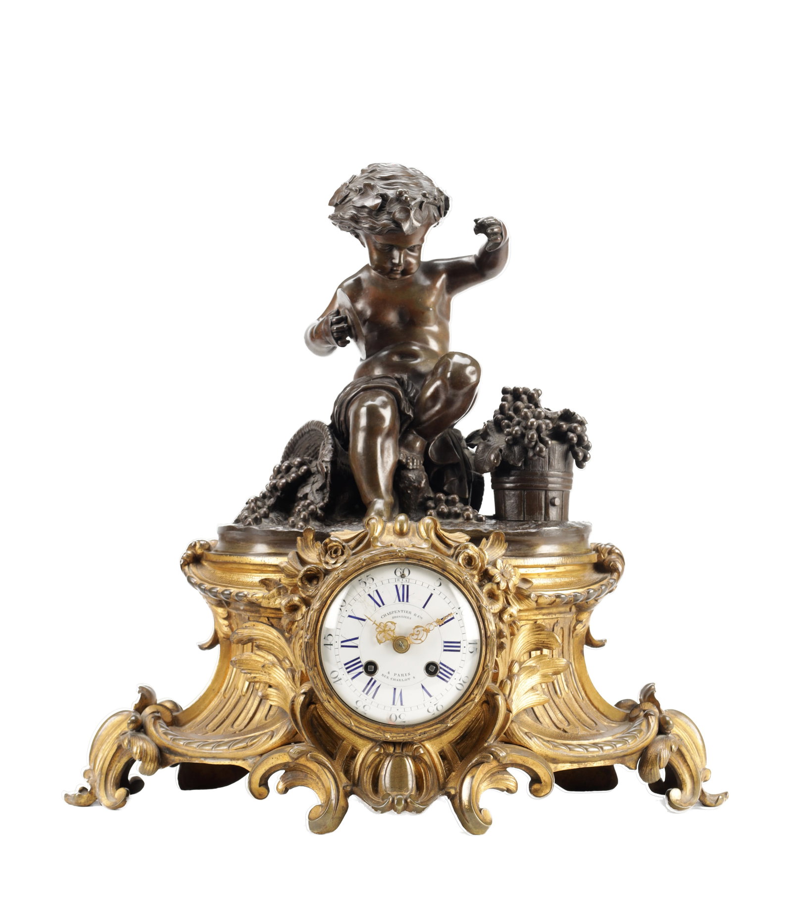 A LATE 19TH CENTURY FRENCH BRONZE AND ORMOLU FIGURAL MANTEL CLOCK: A LATE 19TH CENTURY FRENCH BRONZE AND ORMOLU FIGURAL MANTEL CLOCK the patinated bronze modelled as a putto with grapes beside a basket on a rococo scroll cast ormolu base centred by a circular white e