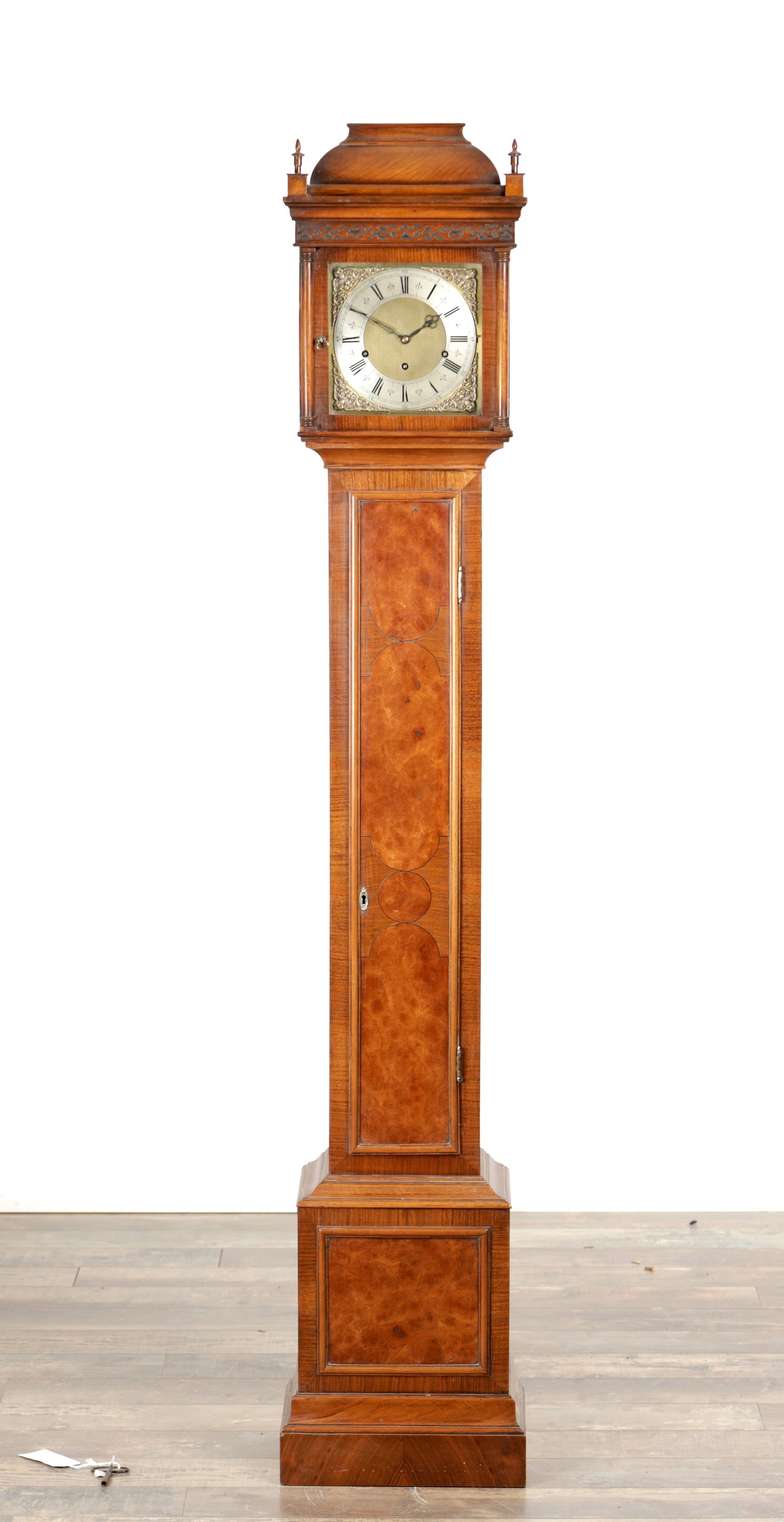 AN EARLY 20TH CENTURY WALNUT ELLIOTT QUARTER CHIMING GRANDDAUGHTER CLOCK: AN EARLY 20TH CENTURY WALNUT ELLIOTT QUARTER CHIMING GRANDDAUGHTER CLOCK with caddy top pediment and burr walnut panels, the square brass dial with silvered chapter ring and cast spandrels, enclosing