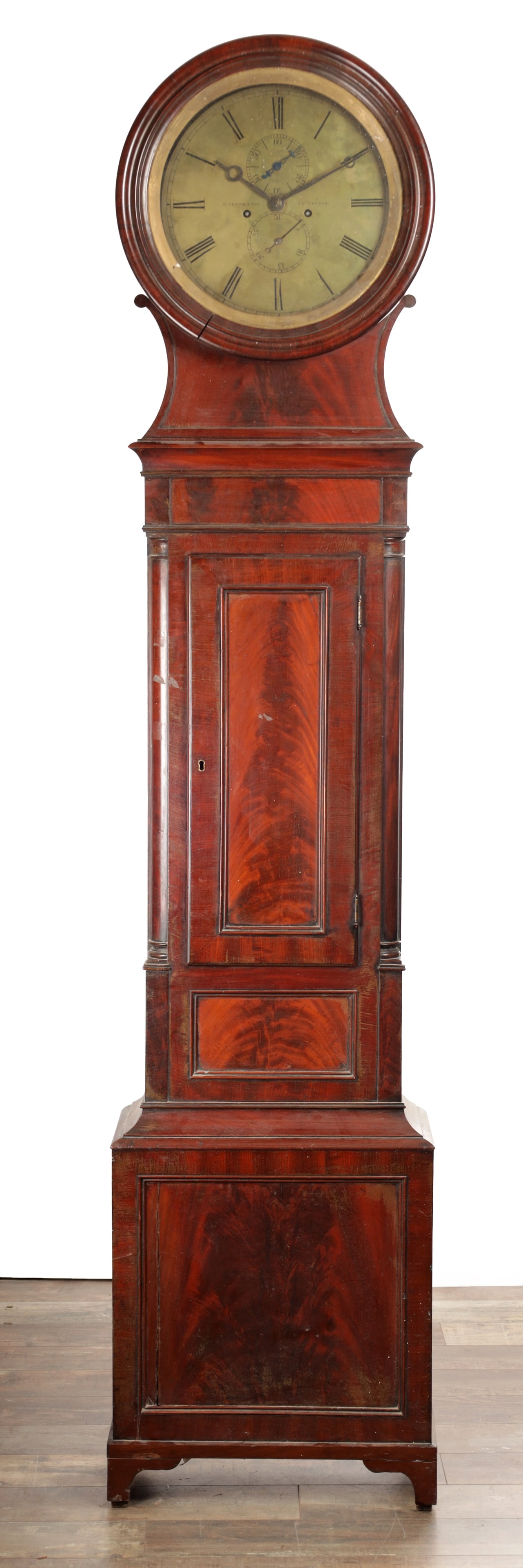 MCGREGOR & SON. EDINBURGH. A LATE REGENCY FIGURED MAHOGANY DRUMHEAD LONGCASE CLOCK: MCGREGOR & SON. EDINBURGH. A LATE REGENCY FIGURED MAHOGANY DRUMHEAD LONGCASE CLOCK with an eight-day weight driven movement striking on a bell, the circular silvered dial with Roman numerals and subsi