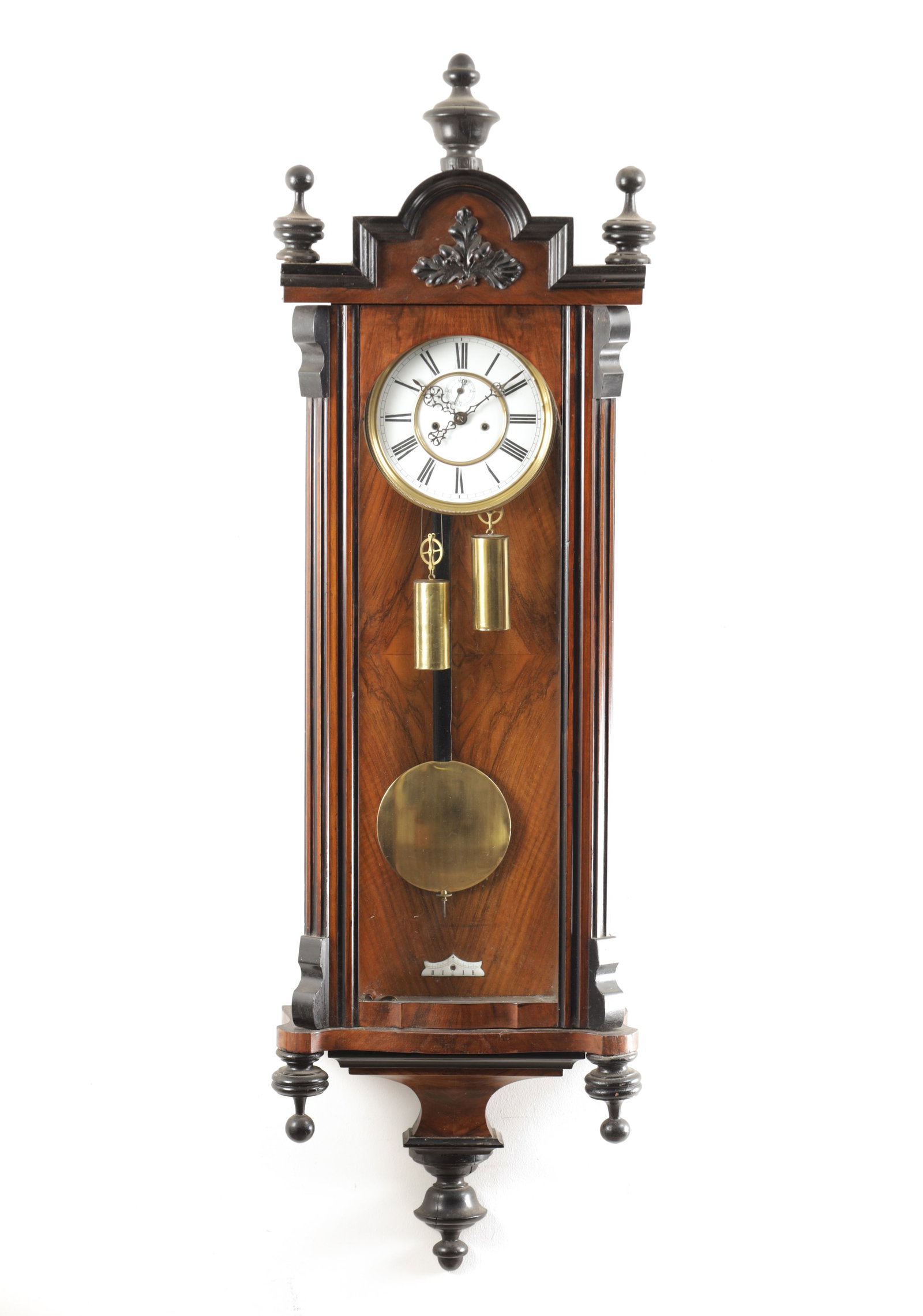 A LATE 19TH CENTURY WALNUT AND EBONISED DOUBLE WEIGHT VIENNA STYLE REGULATOR WALL CLOCK: A LATE 19TH CENTURY WALNUT AND EBONISED DOUBLE WEIGHT VIENNA STYLE REGULATOR WALL CLOCK the shaped pediment with turned finials above a glazed door with canted corners and moulded base enclosing a 7 i
