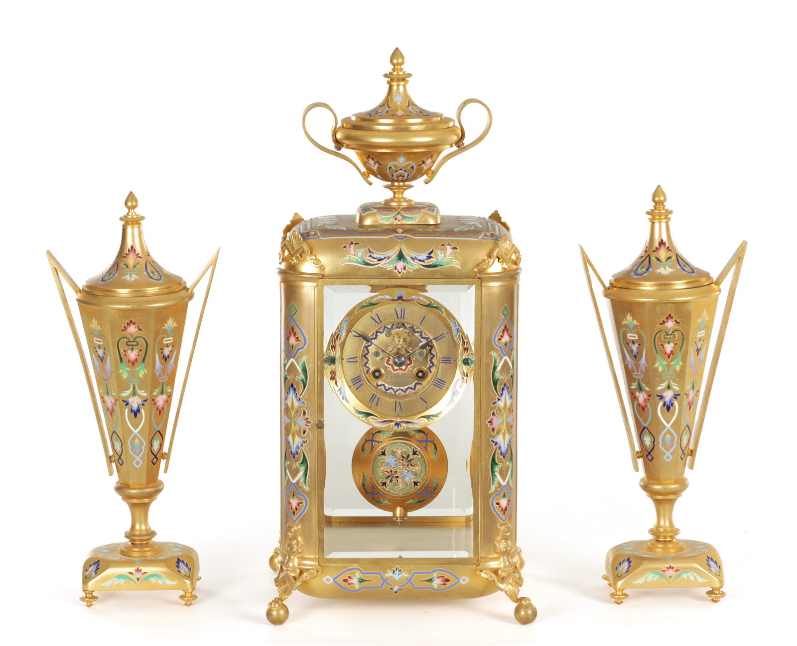 A FINE FRENCH GILT BRASS AND CHAMPLEVE ENAMELLED FOUR-GLASS MANTEL CLOCK GARNITURE RETAILED BY: A FINE FRENCH GILT BRASS AND CHAMPLEVE ENAMELLED FOUR-GLASS MANTEL CLOCK GARNITURE RETAILED BY WILLIAM BATTY AND SON, MANCHESTER the circular two train eight day bell striking movement with large gilt