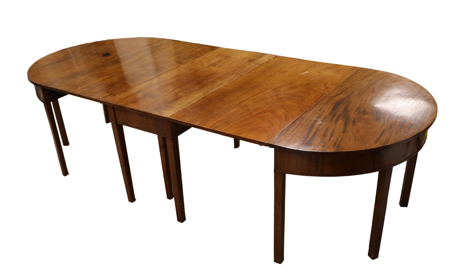 A 18TH CENTURY MAHOGANY D-END EXTENDING DINING TABLE WITH TWO LEAVES: A 18TH CENTURY MAHOGANY D-END EXTENDING DINING TABLE WITH TWO LEAVES of D-end form comprising two demi-lune end sections and two removable rectangular leaves, the plain friezes raised on square taperi
