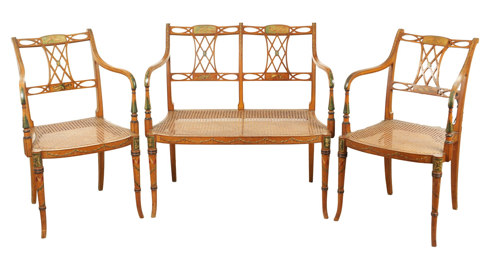 A THREE PIECE 19TH CENTURY SHERATON STYLE PAINTED SATINWOOD BERGERE DRAWING ROOM SUITE: A THREE PIECE 19TH CENTURY SHERATON STYLE PAINTED SATINWOOD BERGERE DRAWING ROOM SUITE comprising a two-seater settee and two open armchairs with classical figural and foliate painted panels, lattice