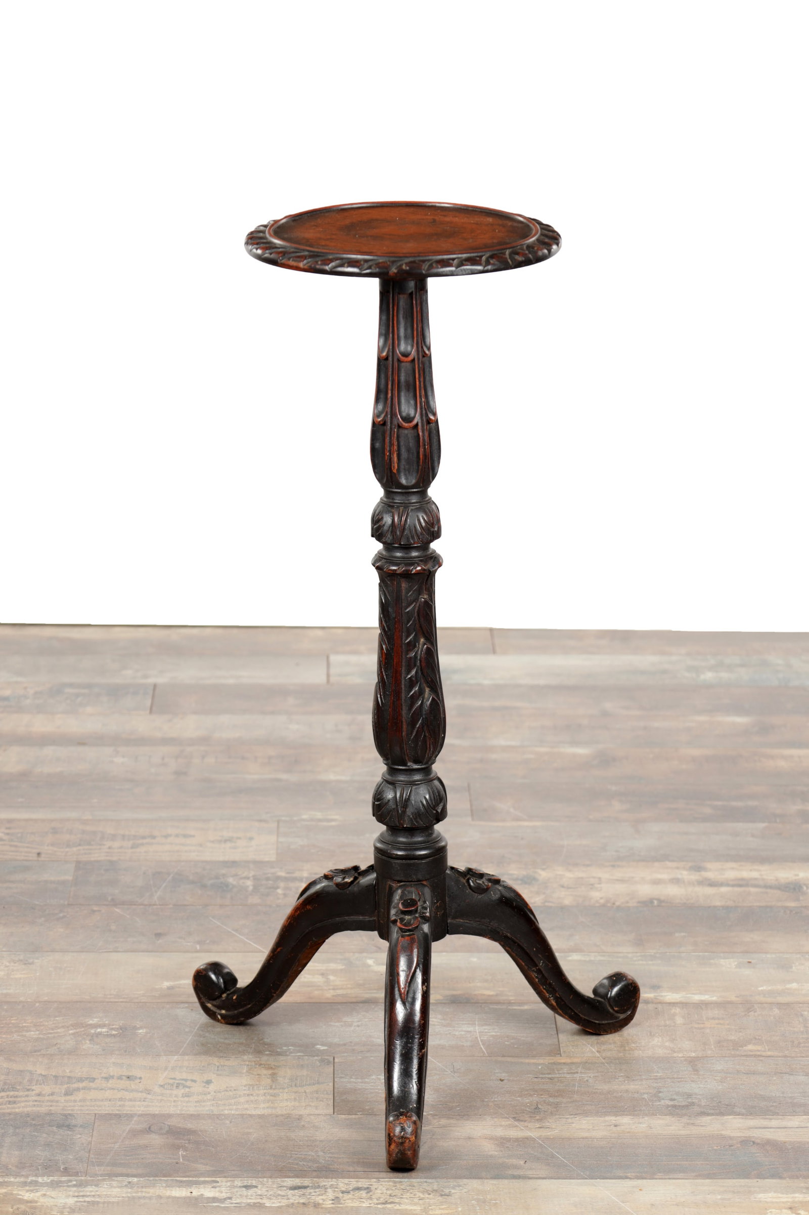 A 19TH CENTURY CARVED OAK KETTLE STAND: A 19TH CENTURY CARVED OAK KETTLE STAND of circular top with carved gadrooned rim on a turned and foliate carved baluster column raised on a tripod base with scroll feet. (80cm high)