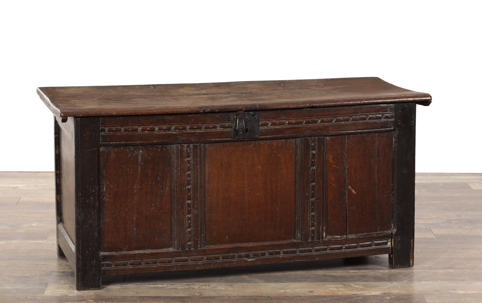 A 17TH CENTURY OAK PANELLED FRONT COFFER: A 17TH CENTURY OAK PANELLED FRONT COFFER with hinged top and steel lock plate. (112cm wide 45cm deep 53cm high )