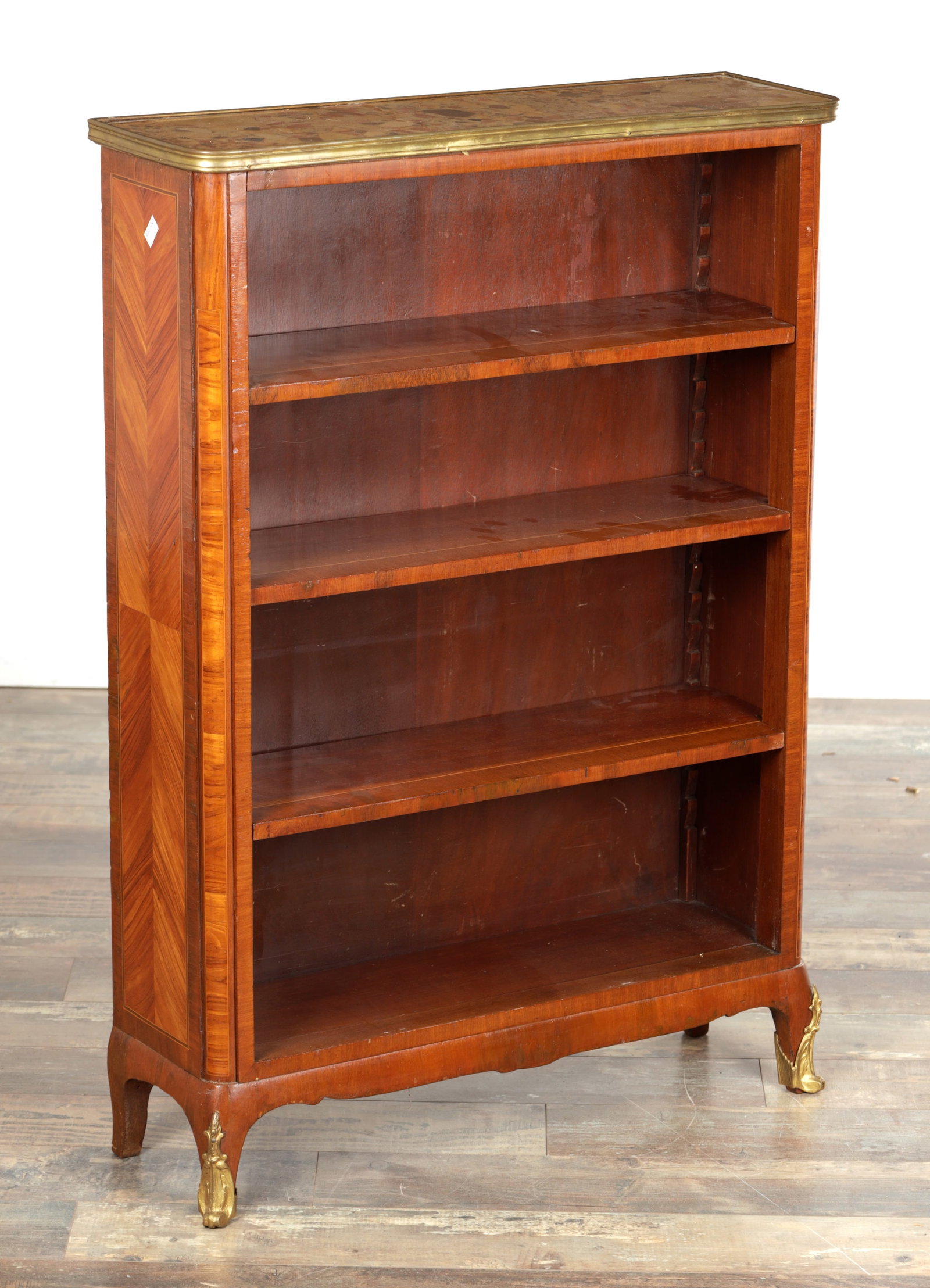 A 19TH CENTURY FRENCH KINGWOOD AND MARBLE TOPPED OPEN BOOKCASE: A 19TH CENTURY FRENCH KINGWOOD AND MARBLE TOPPED OPEN BOOKCASE with a rectangular mottled marble top within a brass moulded edge above three adjustable shelves, the chevron veneered sides with stringi