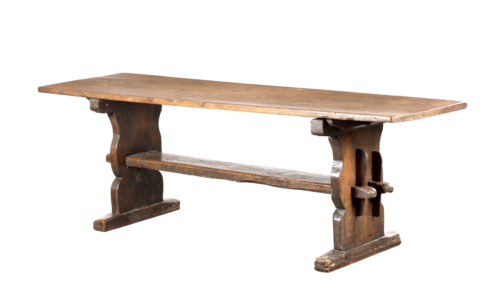 A 17TH CENTURY OAK TRESTLE REFECTORY TABLE WITH ONE-PIECE TOP: A 17TH CENTURY OAK TRESTLE REFECTORY TABLE WITH ONE-PIECE TOP having a single rectangular plank with rounded edges over shaped trestle end supports, the central stretcher with pegged and keyed through