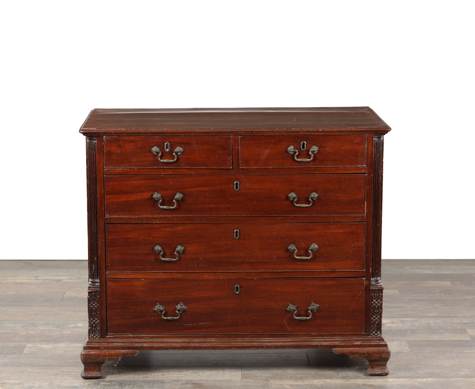 A GEORGE III LANCASHIRE RED WALNUT CHEST OF DRAWERS: A GEORGE III LANCASHIRE RED WALNUT CHEST OF DRAWERS with two short over three long graduated drawers, the top right drawer fitted with small drawers, with brass rococo style handles and reeded quarter