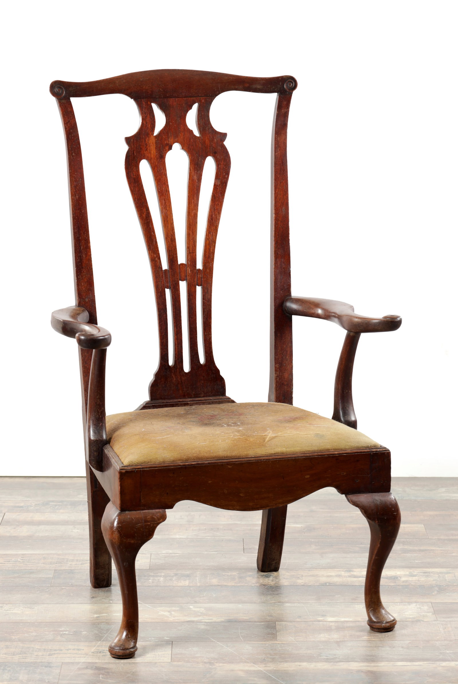 AN UNUSUAL GEORGE II WALNUT OPEN ARMCHAIR OF LARGE SCALE POSSIBLY AMERICAN: AN UNUSUAL GEORGE II WALNUT OPEN ARMCHAIR OF LARGE SCALE POSSIBLY AMERICAN with a shaped arched top rail and pierced vase shaped backsplat, scrolled open arms and a drop in seat, raised on short cabri