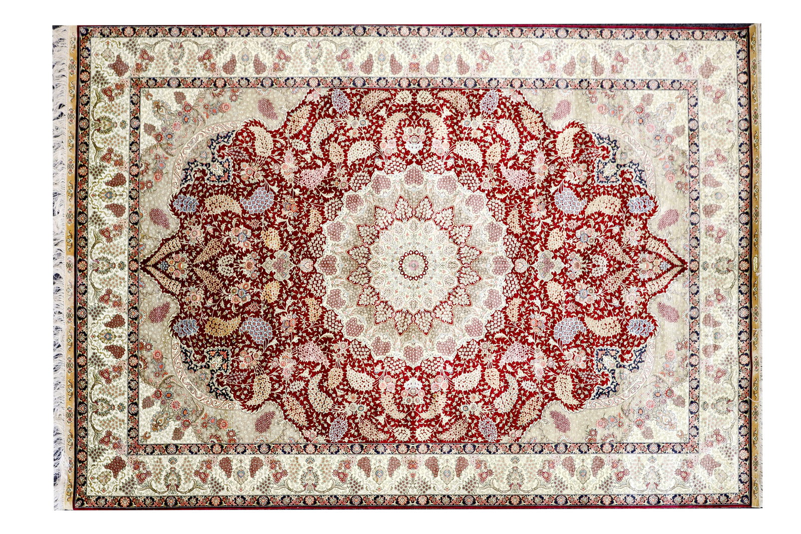 A LATE 20TH CENTURY IRANIAN SILK-ON-SILK CARPET: A LATE 20TH CENTURY IRANIAN SILK-ON-SILK CARPET the deep red field centred by a large lobed medallion issuing dense scrolling floral and foliate decoration, within multiple cream and guard borders of