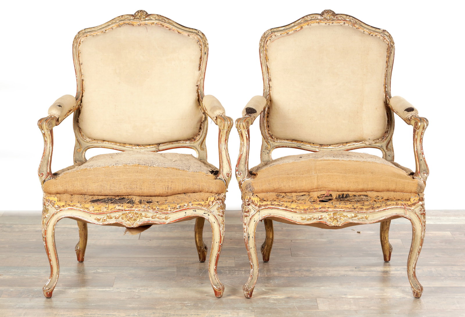 A PAIR OF 18TH CENTURY FRENCH PAINTED WOOD ROCOCO STYLE OPEN ARMCHAIRS: A PAIR OF 18TH CENTURY FRENCH PAINTED WOOD ROCOCO STYLE OPEN ARMCHAIRS with shaped padded backs within moulded and carved frames, outswept scroll arms with padded supports, serpentine seats and foliat
