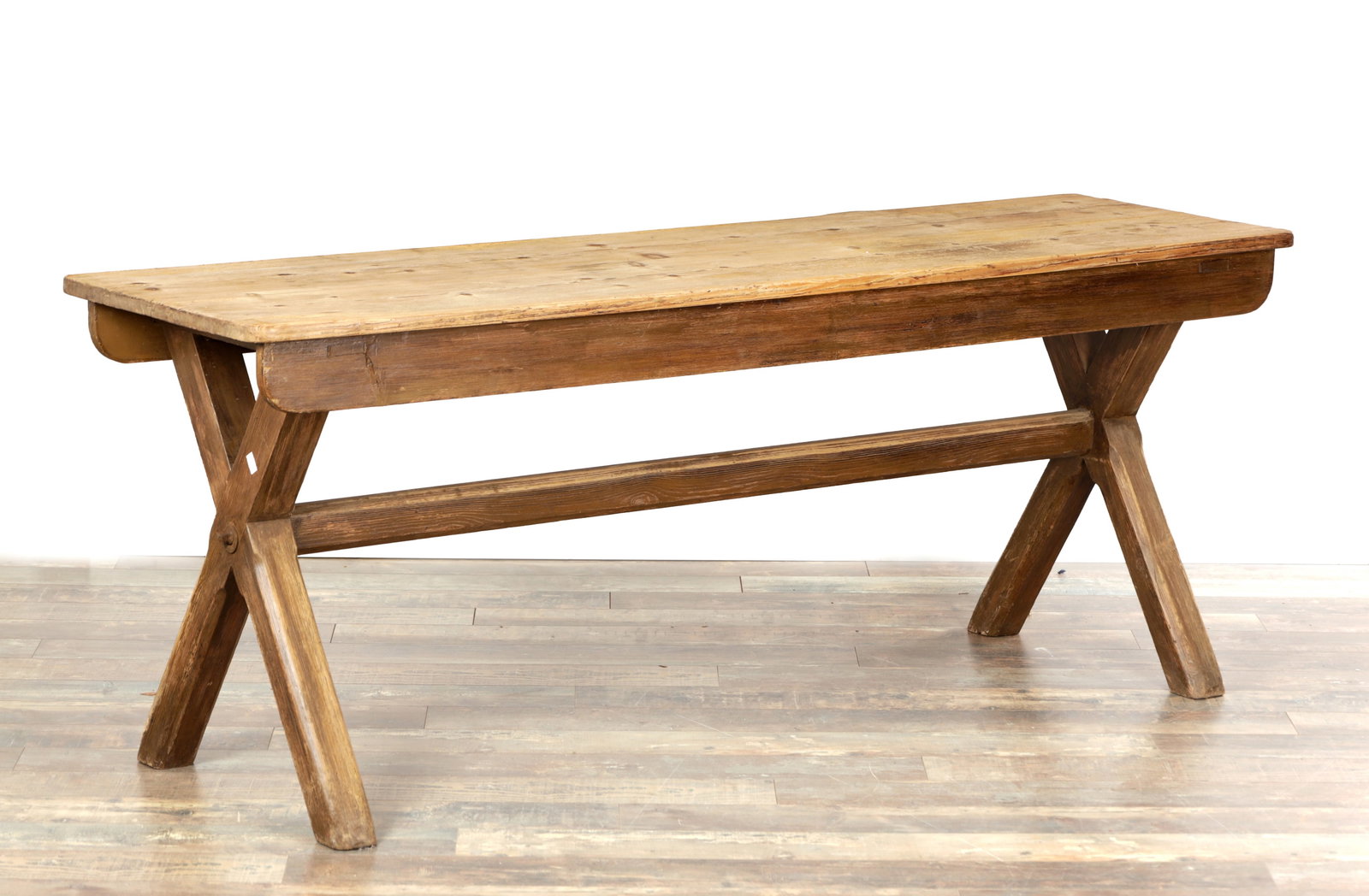 A 19TH CENTURY PINE X-FRAMED TRESTLE TABLE: A 19TH CENTURY PINE X-FRAMED TRESTLE TABLE with a rectangular plank top above plain friezes, the X-form end supports pegged and united by a long stretcher, raised on splayed legs. (184cm wide 55cm dee