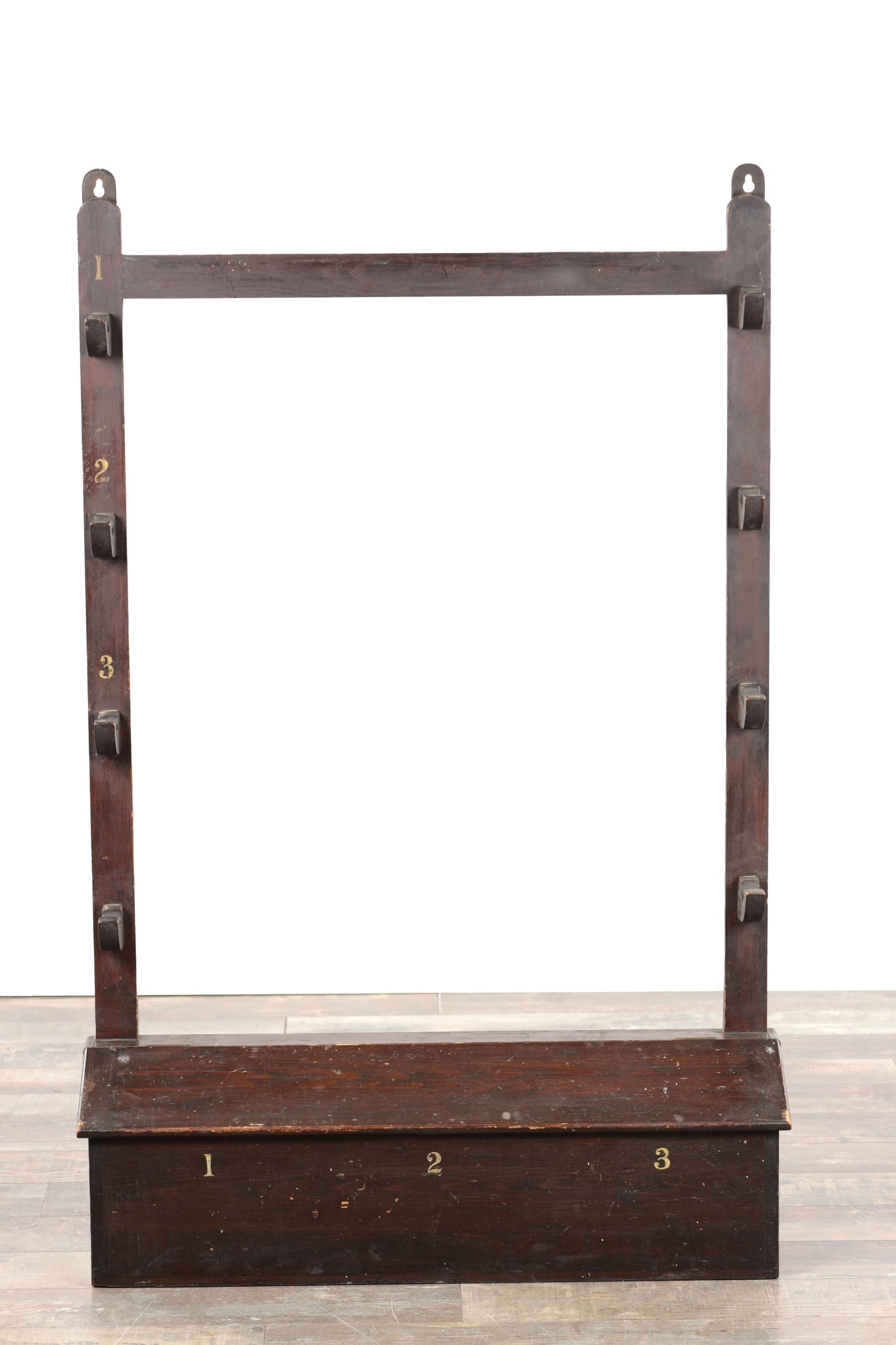 A 19TH CENTURY ESTATE STAINED PINE SHOTGUN RACK WITH PAINTED NUMBERS AND LIDDED BOX BASE: A 19TH CENTURY ESTATE STAINED PINE SHOTGUN RACK WITH PAINTED NUMBERS AND LIDDED BOX BASE of rectangular form for wall mounting with a top rail and six shaped rests to the uprights numbered 1 to 3, the
