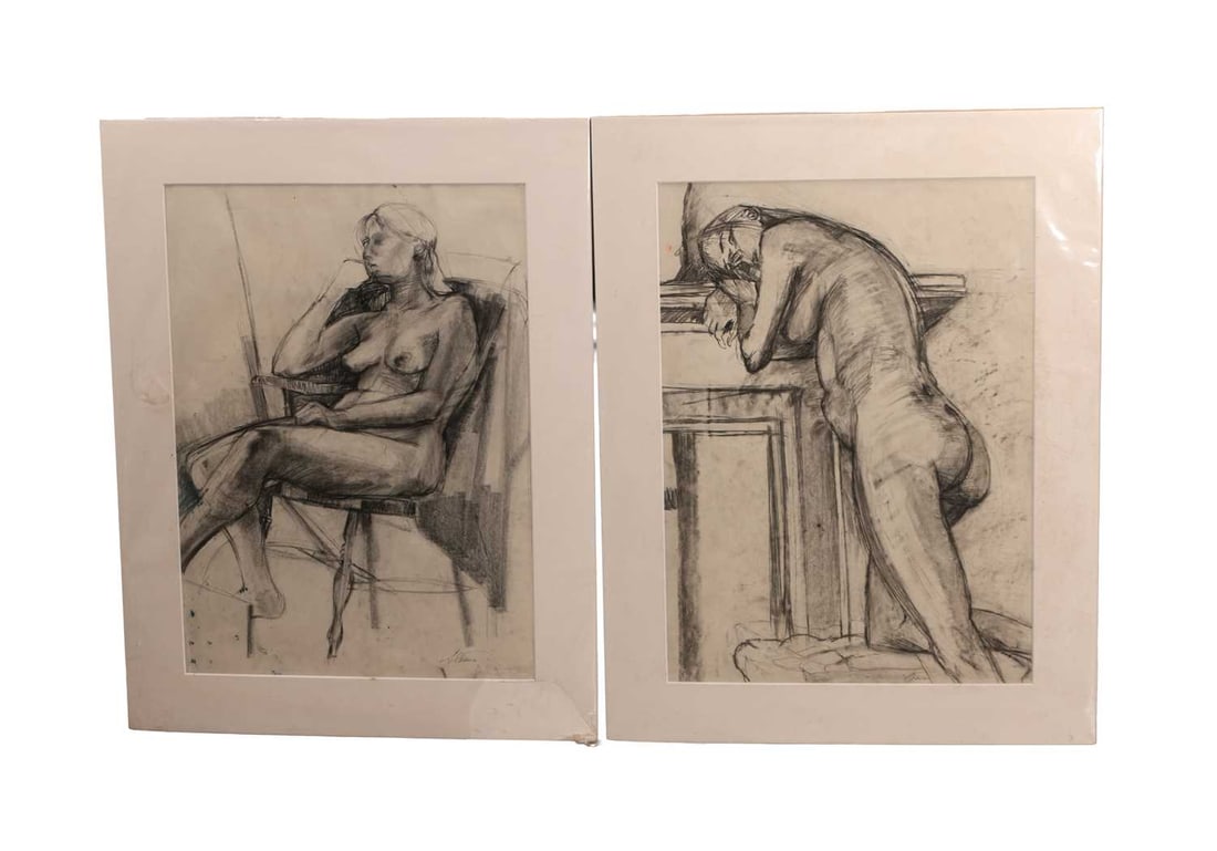 TWO CHARCOAL FIGURE STUDIES: TWO CHARCOAL FIGURE STUDIES depicting a seated female nude in a chair and a standing nude leaning on a mantel, charcoal on paper, each in a card mount. Each 70cm high, 50cm wide