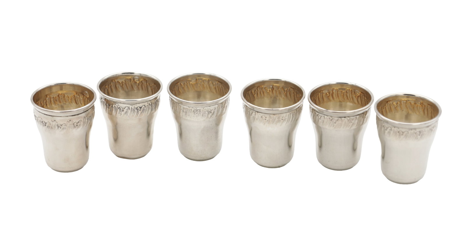 A SET OF SIX FRENCH SILVER CUPS: A SET OF SIX FRENCH SILVER CUPS of small tapering beaker form with a chased foliate border beneath the rim and gilt interiors, total weight app. 70g. (6) (4.2cm high)