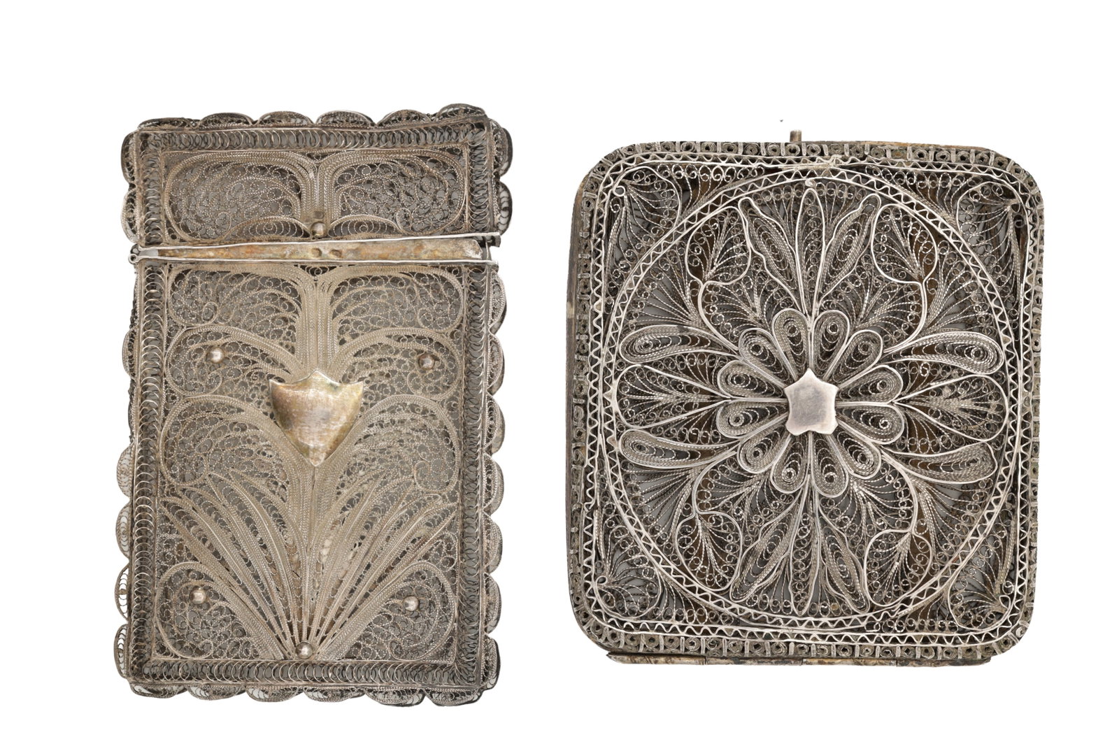 TWO SILVER FILIGREE CARD CASES: TWO SILVER FILIGREE CARD CASES one hallmarked, the hallmarks worn, comprising a rectangular example with scalloped sides and shield cartouche and a rounded rectangular example with radiating