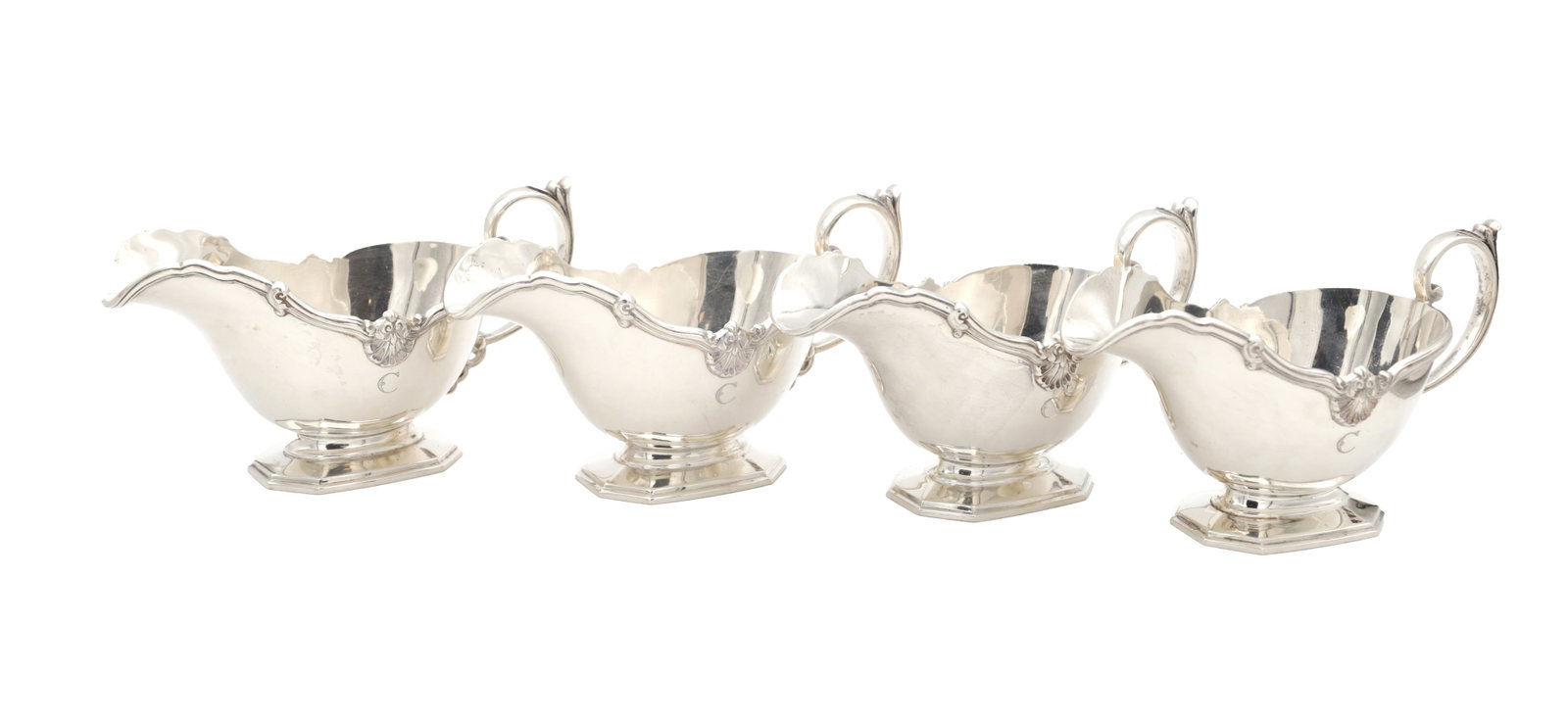 A SET OF FOUR MID 20TH CENTURY ENGLISH SILVER SAUCE BOATS BY MAPPIN AND WEBB: A SET OF FOUR MID 20TH CENTURY ENGLISH SILVER SAUCE BOATS BY MAPPIN AND WEBB of shaped oval form with scalloped rims, scroll handles and stepped octagonal bases, hallmarked Sheffield 1957, total