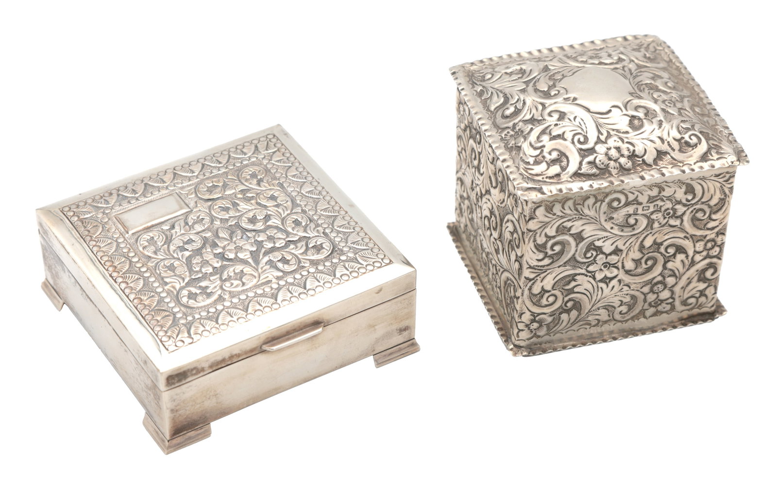 TWO SILVER BOXES: TWO SILVER BOXES one with a wooden interior stamped "Sterling Silver", the other hallmarked Birmingham 1900, both of square form with chased foliate decoration, one with a vacant cartouche and the