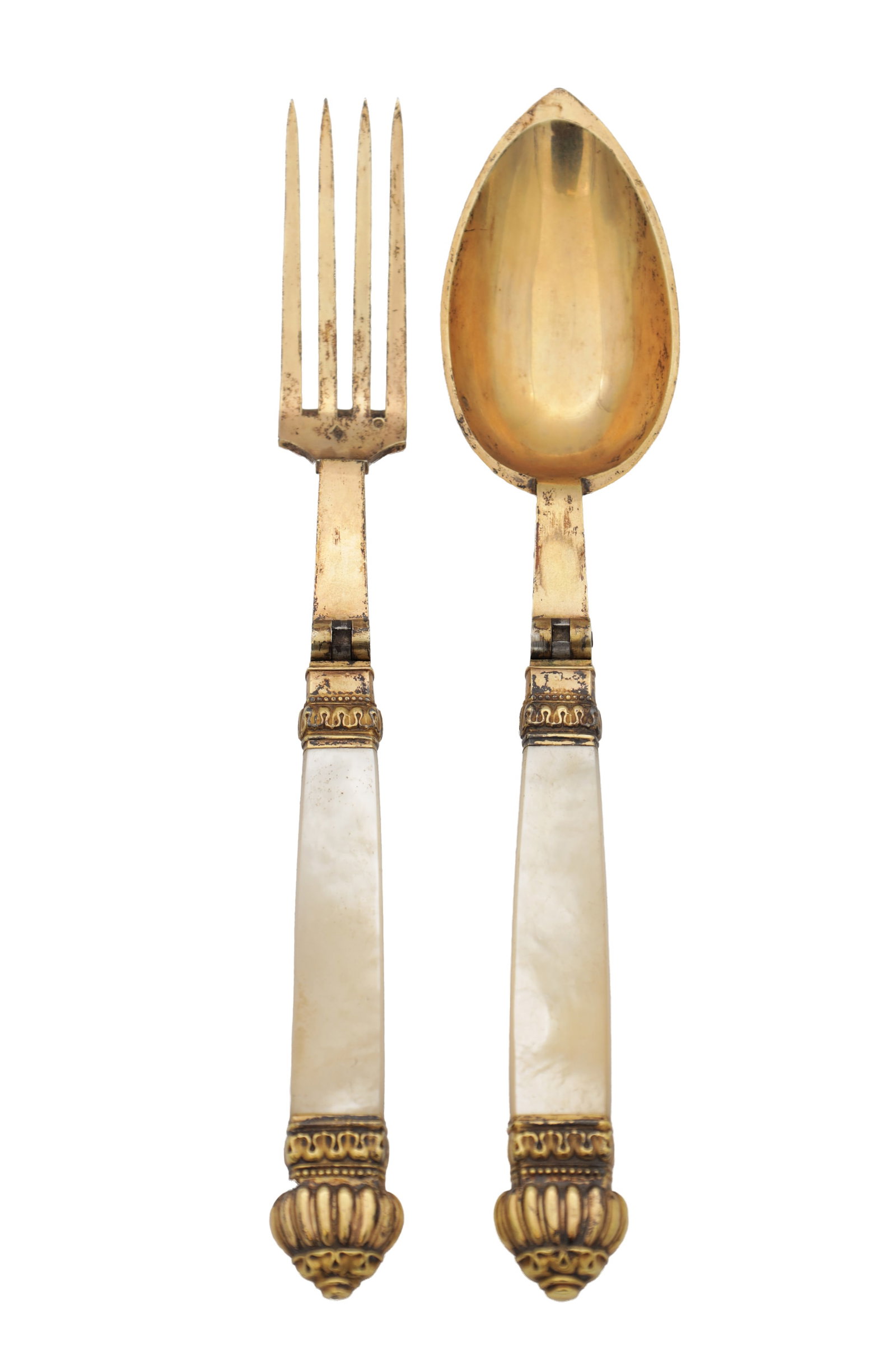 A RARE PAIR OF 19TH CENTURY FRENCH SILVER GILT TRAVELLING SPOON AND FORK WITH MOTHER-OF-PEARL: A RARE PAIR OF 19TH CENTURY FRENCH SILVER GILT TRAVELLING SPOON AND FORK WITH MOTHER-OF-PEARL HANDLES each with a hinged stem folding into tapering mother-of-pearl handles with cast gilt mounts and