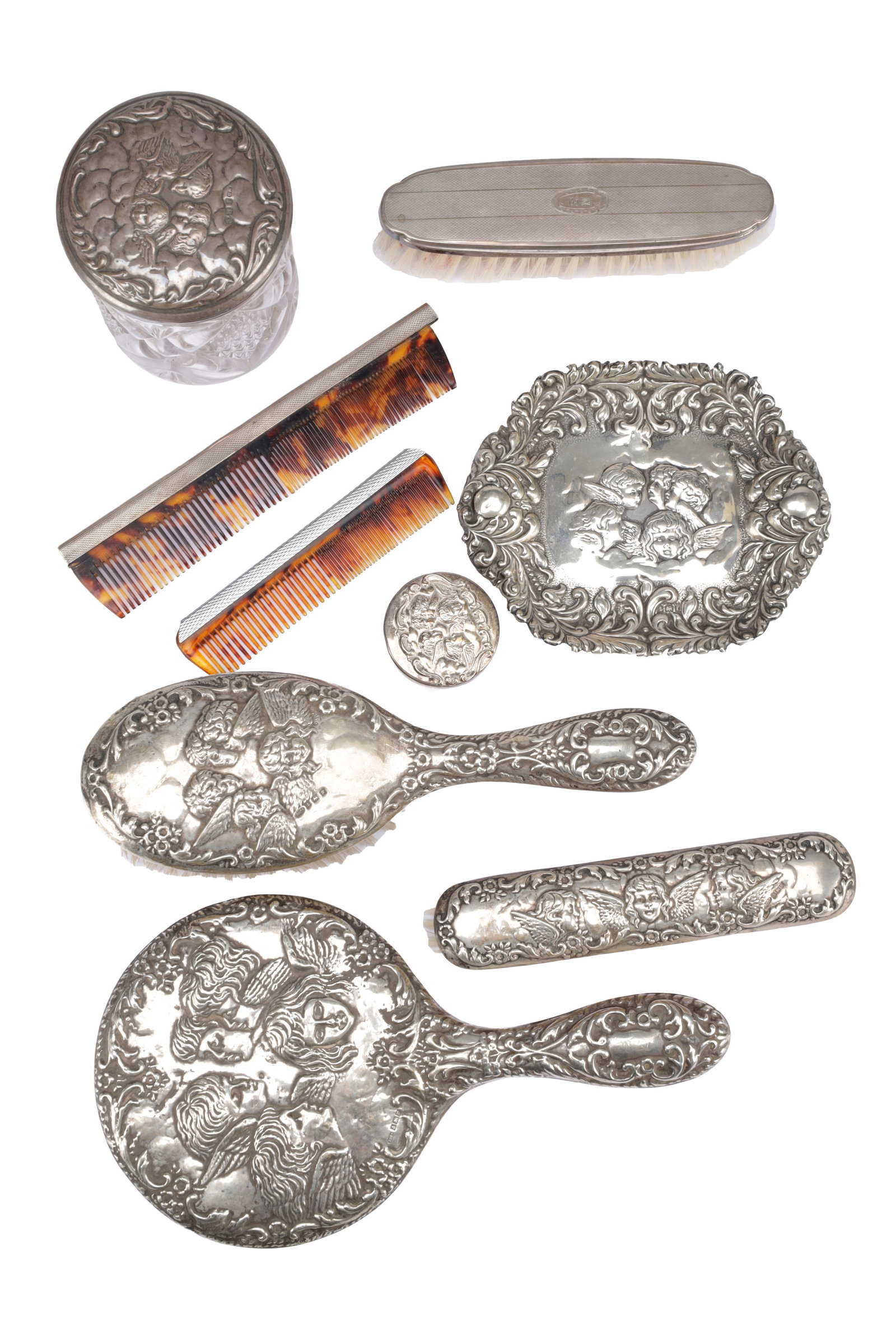 A COLLECTION OF MID 20TH CENTURY ENGLISH SILVER-MOUNTED DRESSING TABLE PIECES: A COLLECTION OF MID 20TH CENTURY ENGLISH SILVER-MOUNTED DRESSING TABLE PIECES including a set by W I Broadway & Co comprising two brushes and a hand mirror; a further set with two combs and a brush,