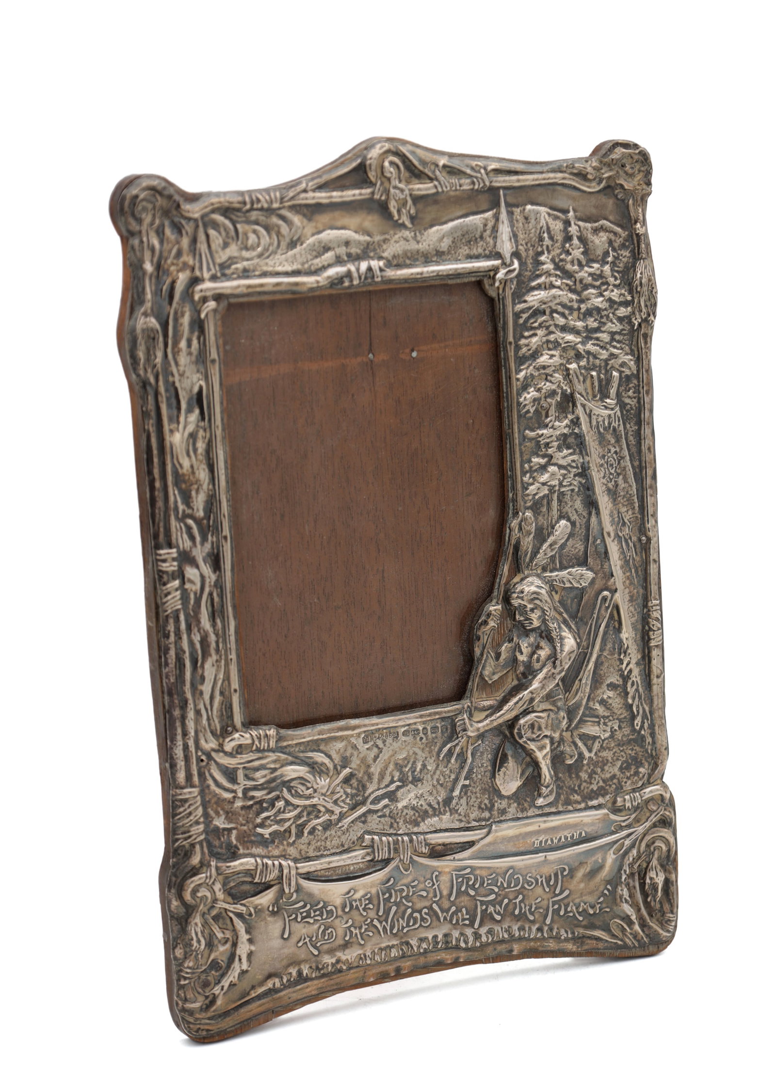AN EARLY 20TH CENTURY ART NOUVEAU SILVER PICTURE FRAME: AN EARLY 20TH CENTURY ART NOUVEAU SILVER PICTURE FRAME hallmarked Chester hallmarked English silver on a wooden backing, it is of repousse form and features Hiawatha with a motto below and scenic