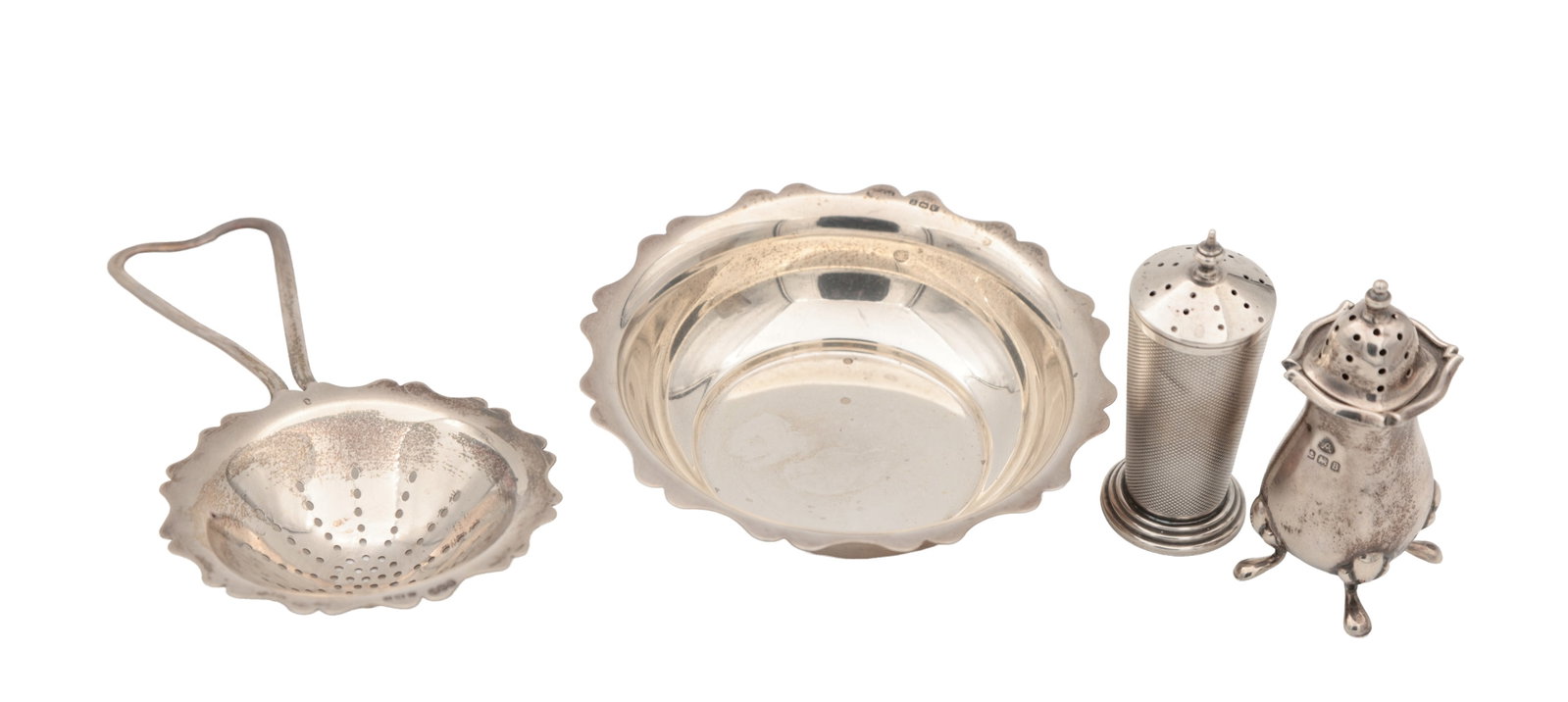 A COLLECTION OF EARLY 20TH CENTURY ENGLISH SILVER ITEMS: A COLLECTION OF EARLY 20TH CENTURY ENGLISH SILVER ITEMS comprising a scalloped dish and tea strainer hallmarked Birmingham 1945 by Edwin Joseph Houlston E J Houlston Ltd together with two casters