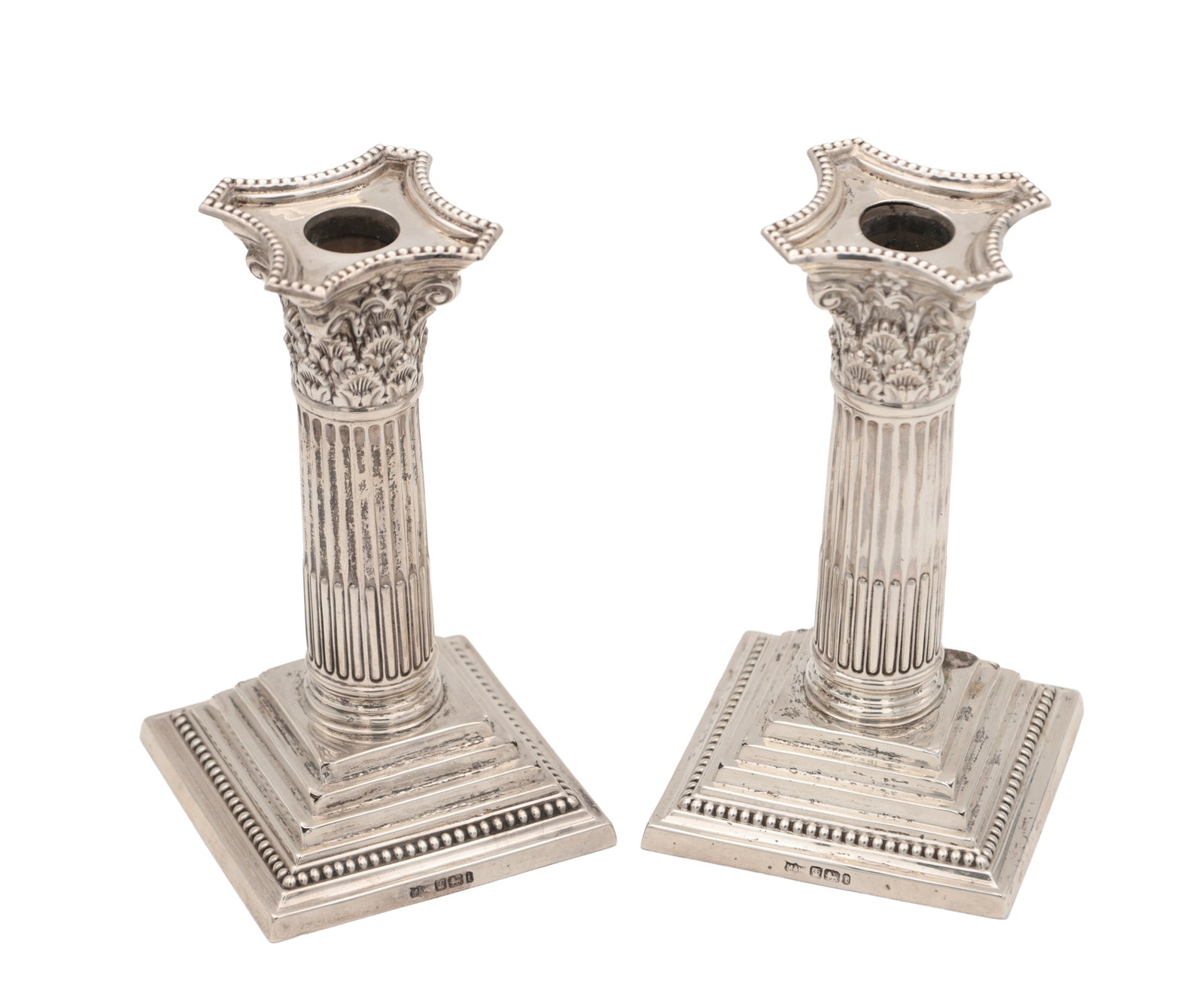 A PAIR OF LATE VICTORIAN ENGLISH SILVER CANDLESTICKS: A PAIR OF LATE VICTORIAN ENGLISH SILVER CANDLESTICKS with fluted column stems and acanthus cast capitals on stepped square bases, Mappin & Webb, Sheffield 1901.